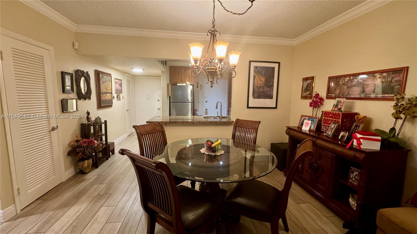 veiw of dining room and eat-in kitchen behind -- furniture is also for sale