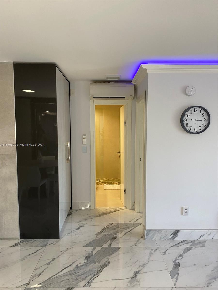 Custom made closet on the left. AC is above the door frame. Custom made lighting.