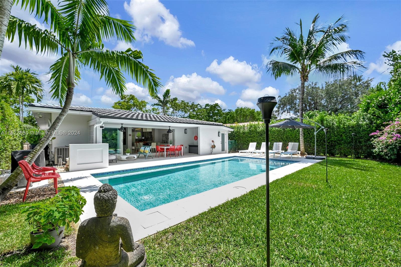 Excellent opportunity to own this modern home on prime location of coral gables golden triangle steps from Biltmore Hotel. Located in much desired tree lined street within walking distance to parks, recreation, markets and downtown coral gables. House has been updated with new bathrooms, high impact windows,italian kitchen with Miele and Sub zero appliances, bright spaces with separate dining, living and extra area to entertain. One car garage. Walk into a foyer which separates both entertaining spaces and your private 3 bedroom suites with many closet space. Walk out to private terrace/patio area from both dining living through wall to wall glass modern sliding doors combining the inside with the outside of home. Salt water pool and patio is privately fenced with surrounding landscaping.