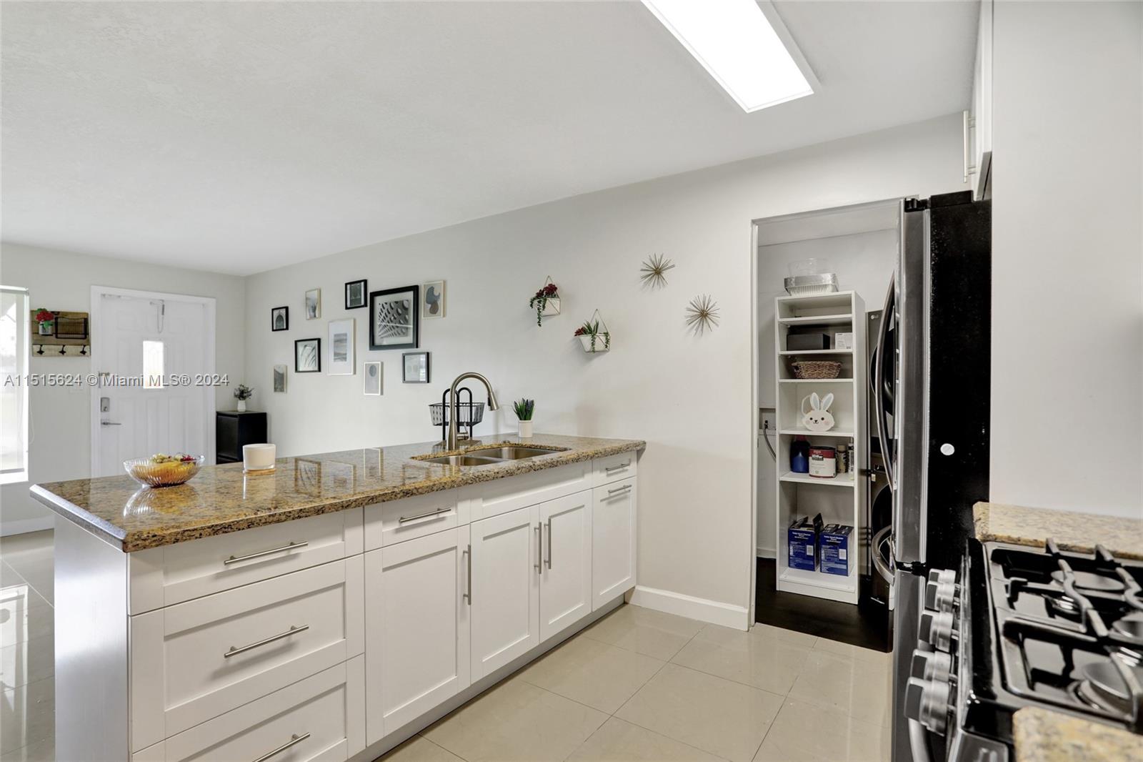 Door entry provides access to multi purpose laundry room.