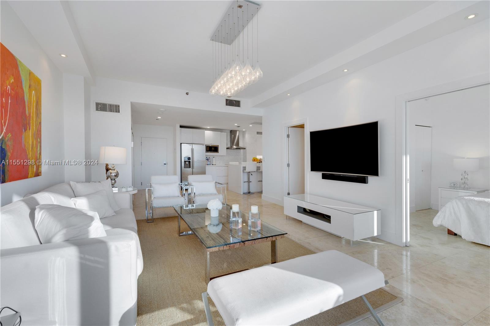 Step into this stunning living room and be greeted by a breathtaking view of the iconic Miami skyline. The floor-to-ceiling windows, complemented by the 10 ft ceilings, flood the apartment with an abundance of natural light, creating a spacious and airy atmosphere. The modern design and open layout make this the perfect space for both relaxation and entertaining, with the vibrant cityscape serving as the ultimate backdrop.