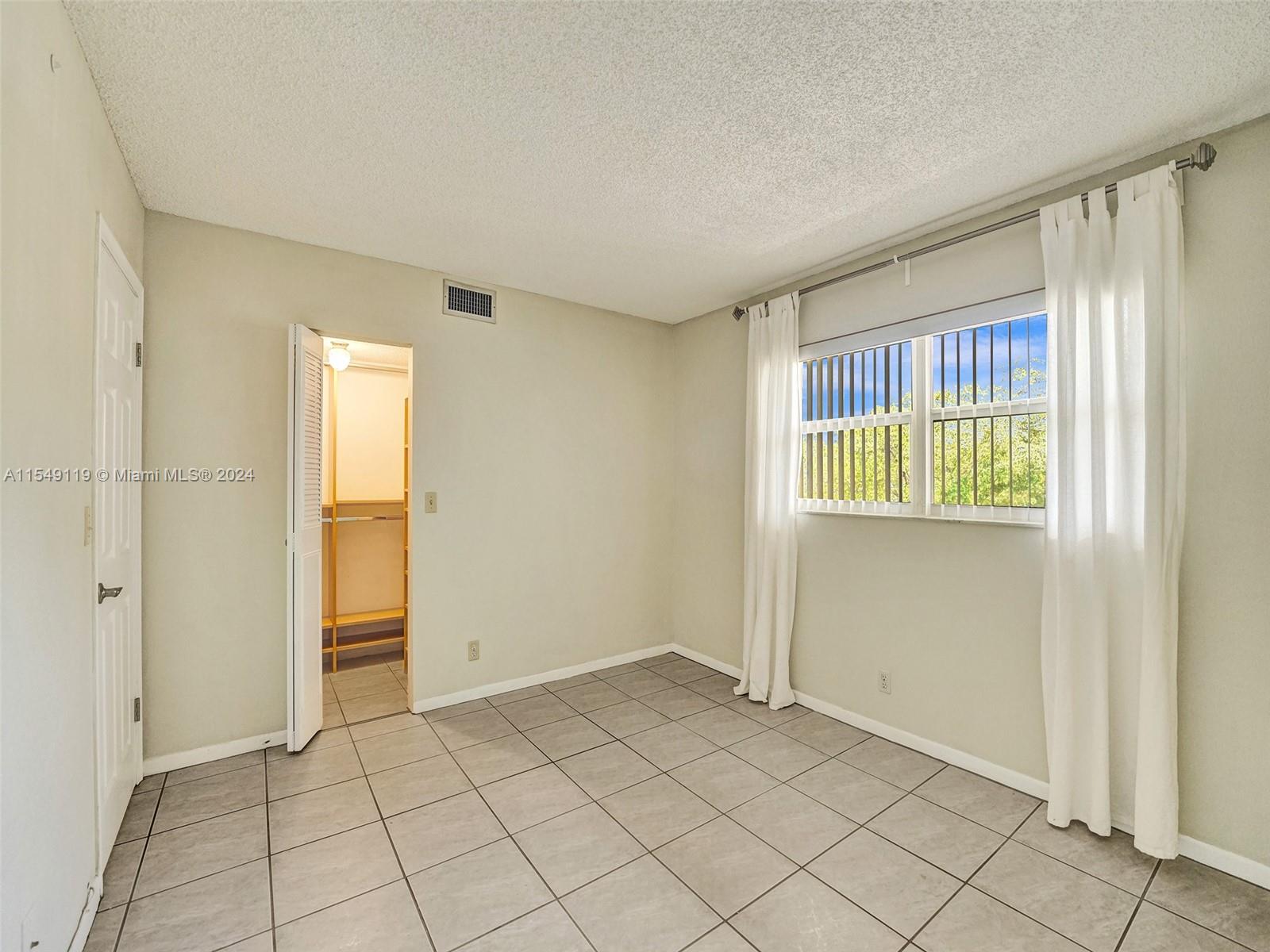 2nd bedroom with walk in closet with bullt ins