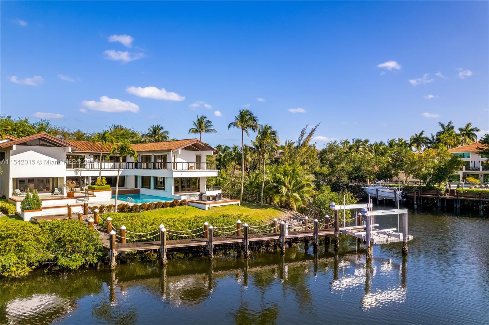 Be amazed by the breathtaking water views from this home with over 300 feet waterfront in Islands of Cocoplum. The spacious driveway leads to a secluded setting for this home with ample spaces overlooking the water views. First floor features formal living room, dining room and family room, two bedrooms and office on first floor. Second floor features a large sitting area, four en-suites and main suite with a sitting area/office space. Large dock with boat-lift and two jet-ski platform were installed a few years ago. Islands of Cocoplum offers great indoors and outdoors amenities: gated entrance, security patrol, clubhouse, tennis courts, pool and exercise room. Please make sure to check out the video!
