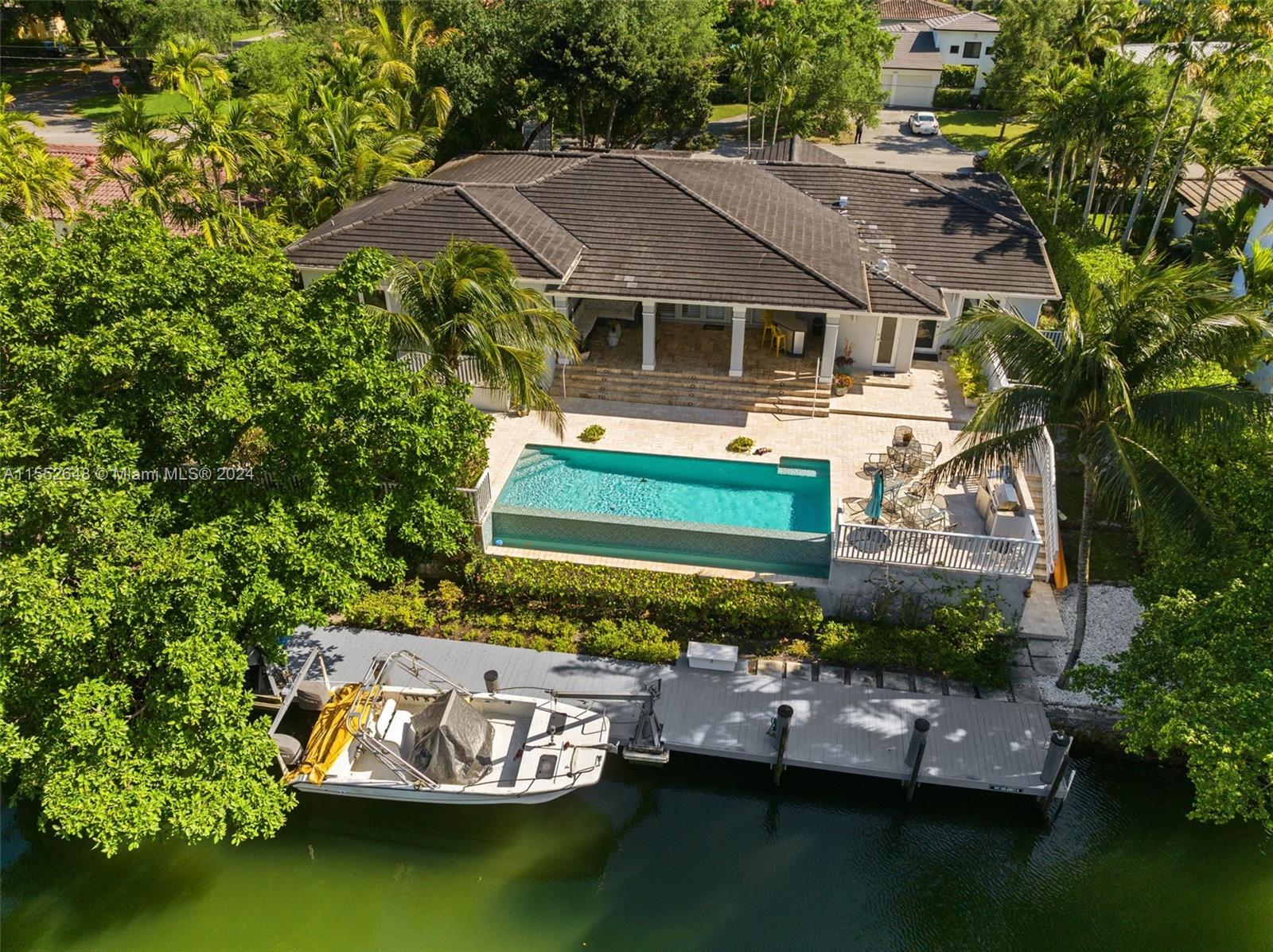 This exquisite 4-bedroom, 4.5-bathroom waterfront residence offers an unparalleled living experience, with direct access to the highly sought-after Coral Gables Waterway. It provides a 70-foot dock and a boat lift, perfect for boaters and water sport enthusiasts. The home has been meticulously updated, featuring an open-space layout designed to enhance the flow of natural light and views of the outdoors, including an infinity pool that seamlessly blends with the serene waterway. The well-appointed primary room showcases
oversized walking closets, a spa-like bathroom with dual sinks, and separate tub and showers. Its central location is near schools, businesses, entertainment and shopping districts, the airport, hospitals, and the Biltmore and Riviera Country Club golf courses