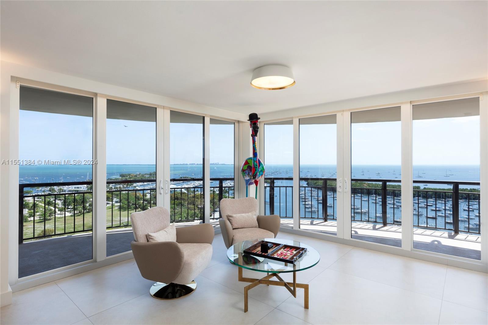 A modern haven in the sky with the most PRICELESS views in all of Coconut Grove. The 180 degrees of glass let you take in sparkling Biscayne Bay, Downtown, and Key Biscayne from every angle. With generous and thoughtful entertaining spaces including a chef’s kitchen with full bar and seating, wraparound balconies, dining room with video wall, and game area, your guests will be dazzled by more than just the vistas. Enjoy unparalleled walkability to center Coconut Grove and its dining and shopping. Amenities come up to you with private gym, sauna, steam room, and jacuzzi. When you’re ready for relaxation, retreat to a primary suite with two walk-in closets and striking stone wet room with freestanding tub and double shower. Large in-unit storage room plus six assigned parking spaces.