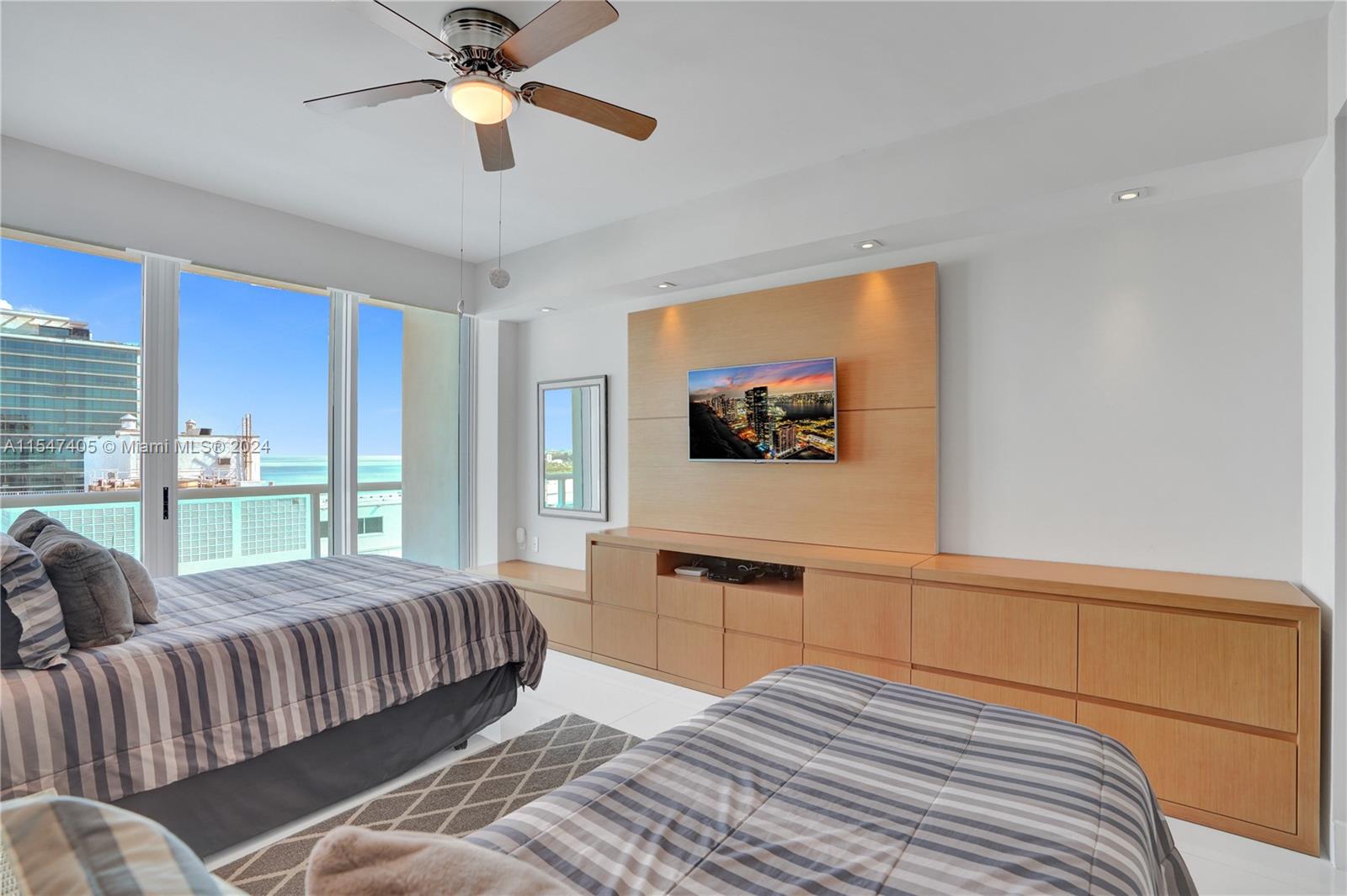 Suite 1 with walk-in closet, balcony access and personal items storage.