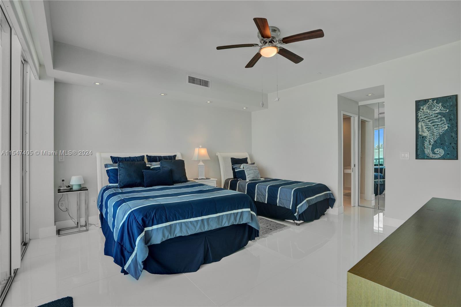 Suite 2 with balcony access and plenty of personal items storage.