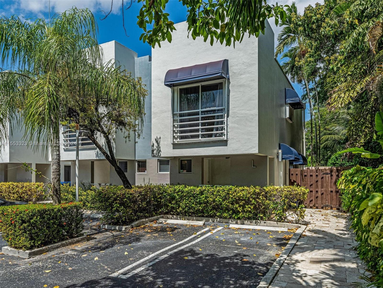 Welcome to this modernized 2/2.5 end-unit townhome in the gated & highly secured GroveDeco complex located in the heart of the Grove! Upon entry, prepare to be greeted by a chef's kitchen with high-end LG appliances that seamlessly connects to the living & dining room. Being one of the only end-units in the entire complex, enjoy your private oversized side yard. Upstairs, the skylight creates an open & airy sensation. 2 large en-suites w/ oversized closets & private terraces. The primary suite boasts an updated bathroom & is flooded w/ natural light. GroveDeco residents get to enjoy a private community pool enveloped by lush landscaping that is located directly next to the unit. Don't miss out on this opportunity of calling this gated & secured townhome in the heart of the Grove yours!