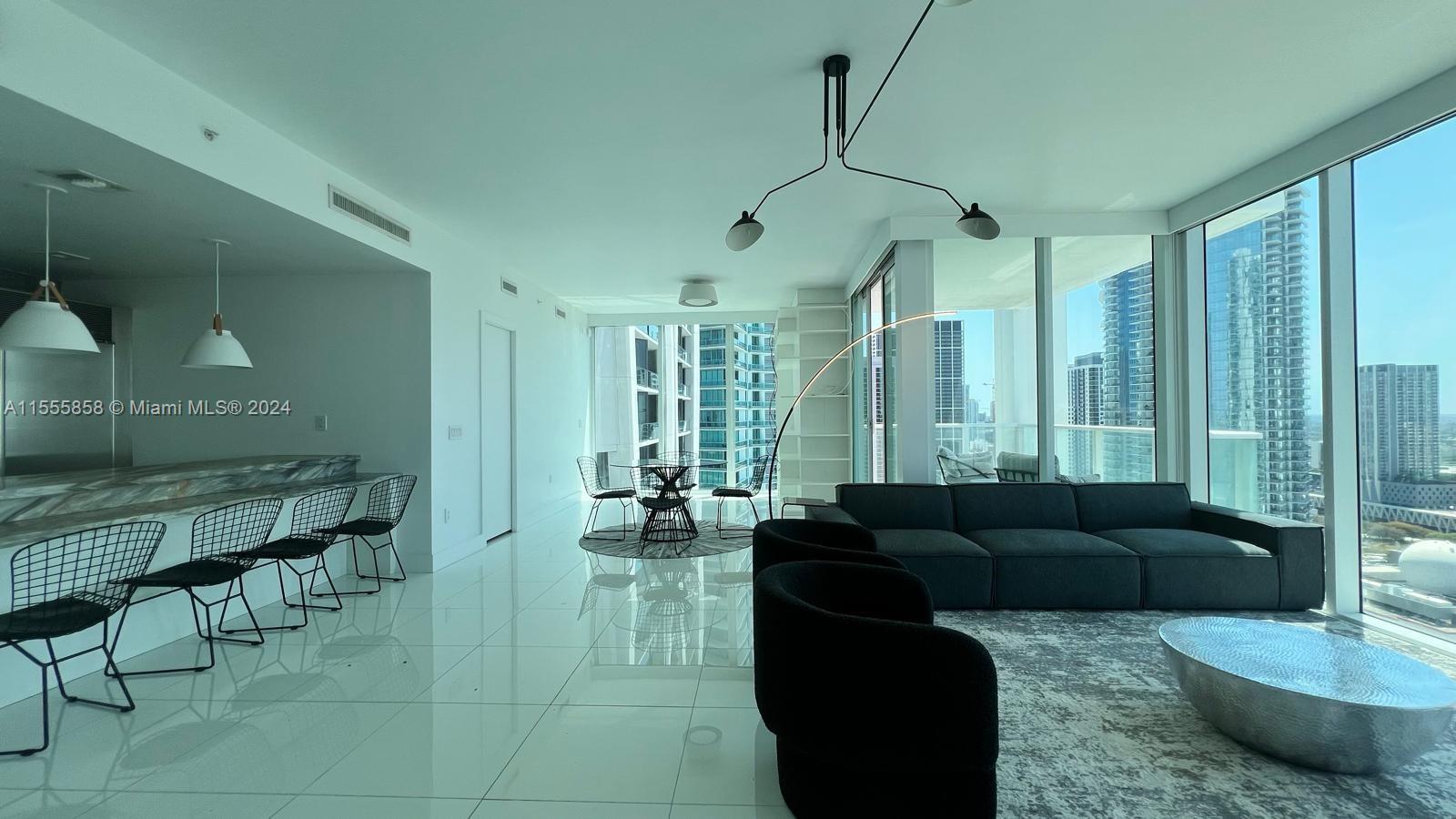Amazing loft-style high floor 2 bedroom, 2 bathroom in Ten Museum Park, one of the most desirable luxury buildings in Downtown Miami.  Open concept layout allows for spacious living, kitchen, dining, entertainment or 2nd bedroom areas with stunning views from floor to ceiling windows. Brand new furniture, updated with marble countertop kitchen island, updated bathrooms, custom closets, built out bar/pantry with a wine beverage fridge, marble floors throughout, full size washer and dryer, two valet parking spots. This building offers high end resort style amenities including multiple poos, state-of-the art fitness center, luxurious spa, Beach club service, full front desk concierge, 24hr security and valet. Centrally located to all Miami has to offer. You will love living here.