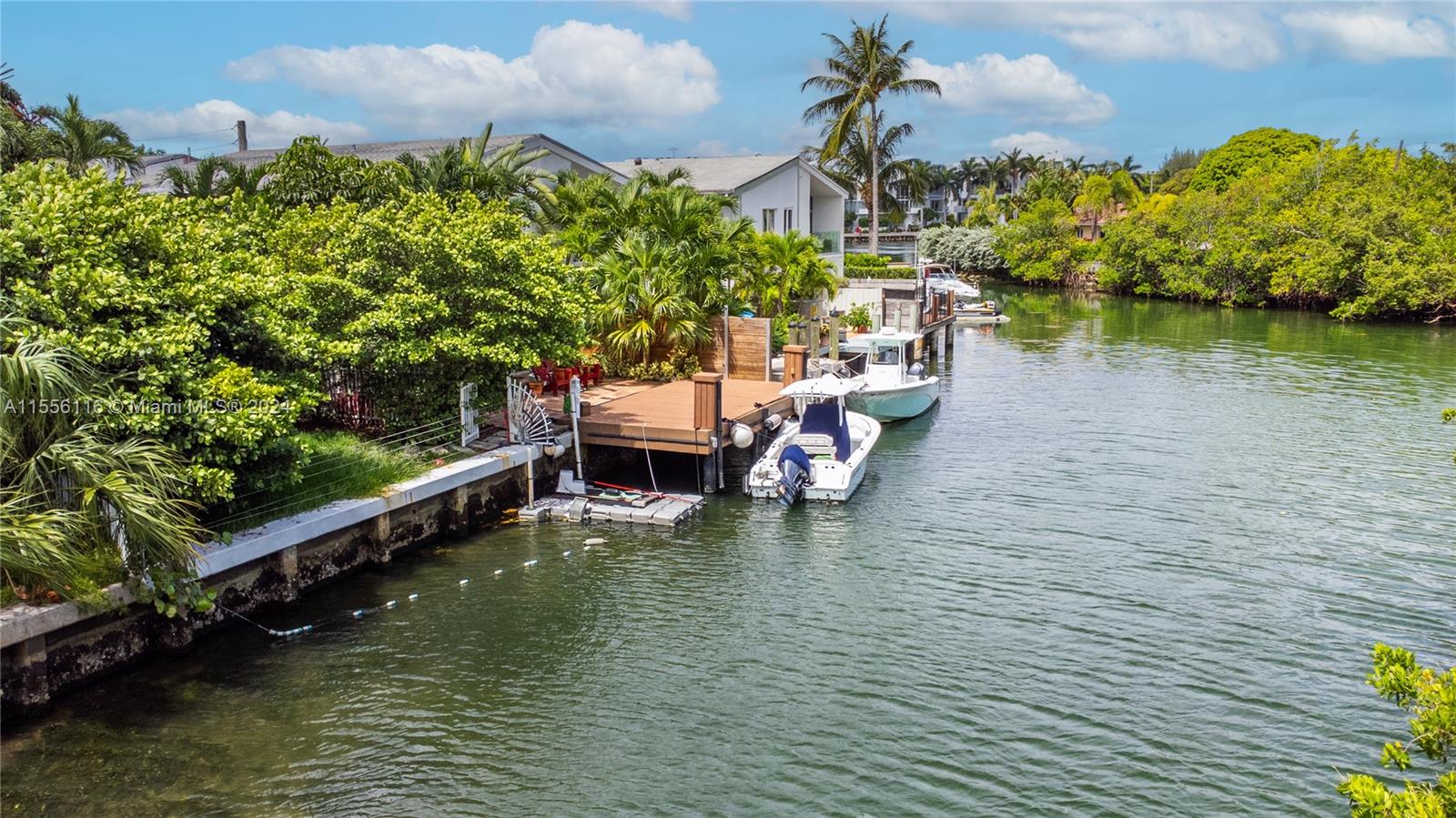 RARE FIND ON MIAMI BEACH:  Waterfront home with two boat slips and a large private yard just walking distance to the beach. Open bay access and no fixed bridges.  This does not exist anywhere else on the beach. True boater’s paradise. Neighboring waterfront lot included in sale-over 80 feet of available seawall & 2 boat slips! This spectacular updated 3 bed, 2 & 1/2 bath waterfront townhome with no HOA fee is being offered w/a 30 ft. dock w/boat slip, kayak launch, & has open bay access w/no fixed bridges. Featuring incredible views w/unmatched privacy & serenity. The sophisticated interior design w/large format porcelain floors downstairs & bamboo upstairs, open designer kitchen, & separate laundry room. Ideally situated walking distance to beach, restaurants, shops, houses of worship...