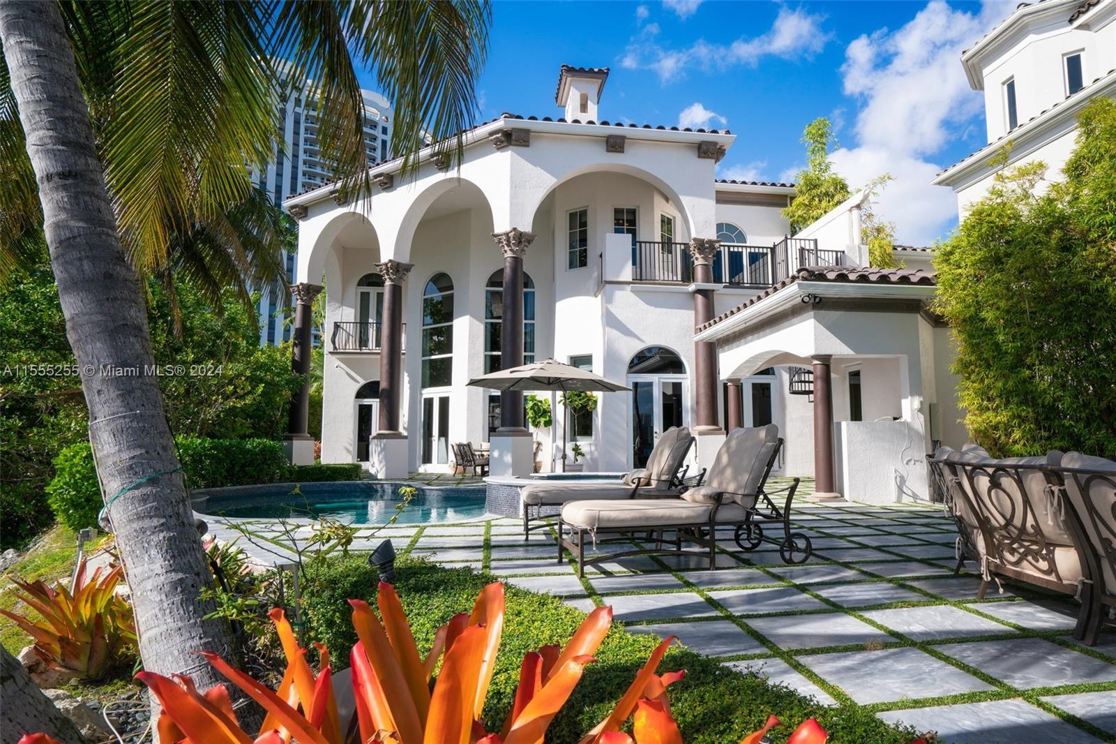 Own a former celebrity bayfront three-story Mediterranean estate in the prestigious gated community of Island Estates. The only home on a double lot of 24,772sf with 240ft of water frontage. Top-of-the-line finishes, vaulted 30-foot ceilings, gourmet chef's kitchen, elevator, luxurious master suite with sitting area and veranda with sunrises and sunset panoramic views. Stunning tropical pool and spa overlooking the bay. Marble and walnut hardwood floors, impact glass, 50ft boat docks with electricity and water. Ipad-controlled smart house system, movie theater with 128-inch TV, cabana, elevator, office, service quarters, and golf cart parking. and 14K Gold Chandeliers with Swarovski Crystals with a special cleaning system. Residents have complete access to Prive five-star amenities.