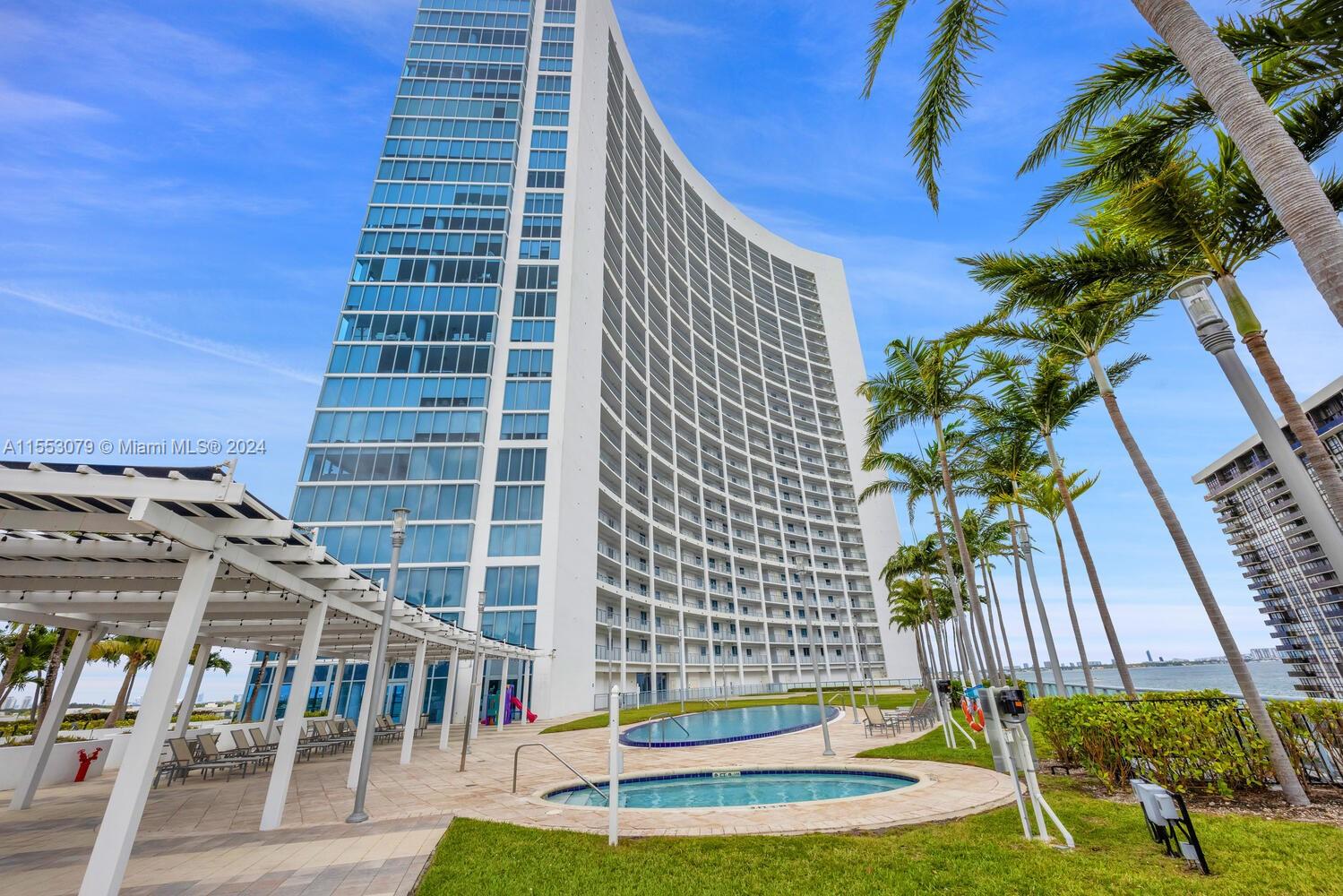 Immerse yourself in luxury with this exclusive Miami waterfront condo in the prestigious 12 line. This 1,870 sqft corner unit features 2 beds & 3 baths, offering panoramic 270-degree views of Biscayne Bay, Miami Beach, & the city skyline via expansive floor-to-ceiling windows. The open layout showcases an Italian kitchen with granite countertops, S/S appliances, marble floors, custom closets, & renovated bathrooms. Opt for partially furnished or vacant spaces, complete with premium fixtures, in-unit laundry, & 2 reserved parking spots. Amenities: dual pools, a Jacuzzi, BBQ area, media & party rooms, a theater, gym, spa, business center, & 24 hr concierge service. Situated a stroll away from the Design District & Midtown Miami, it ensures effortless connections to Miami Beach & the airport