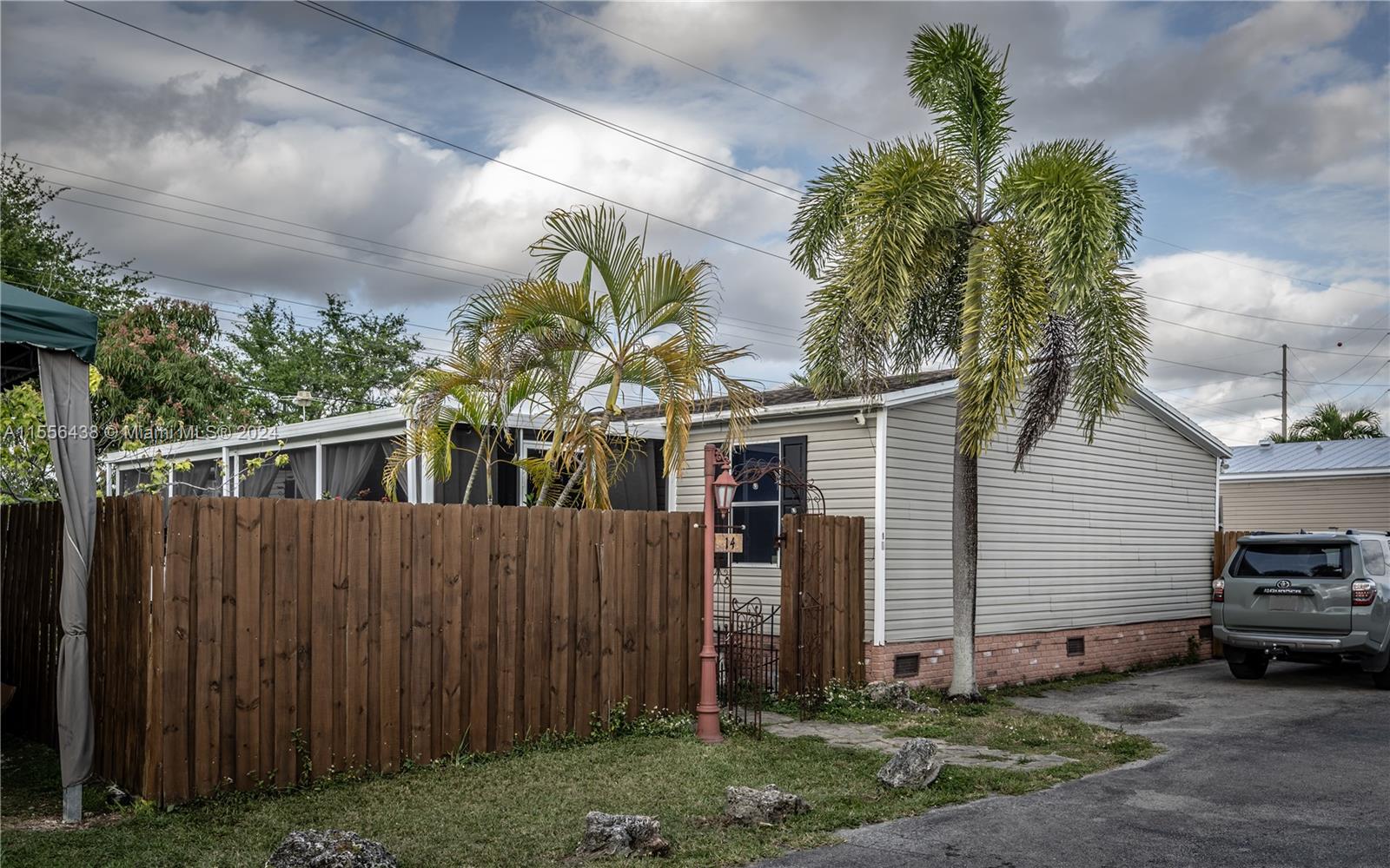 4 bedroom 2 bathroom mobile home located in a well maintained gated community.   This home offers a separate laundry room, a large screened in patio, a detached storage shed, as well as a nice size fenced in yard.  In addition there is a covered carport area.