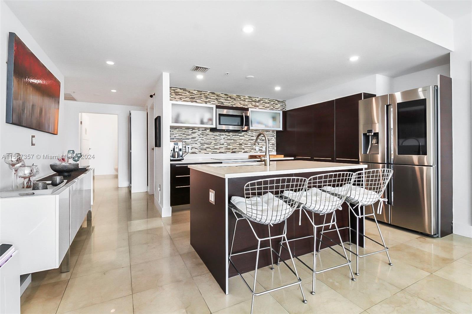 Kitchen features high hat / recessed lighting and stainless appliances.  Central sink for ease of entertaining.