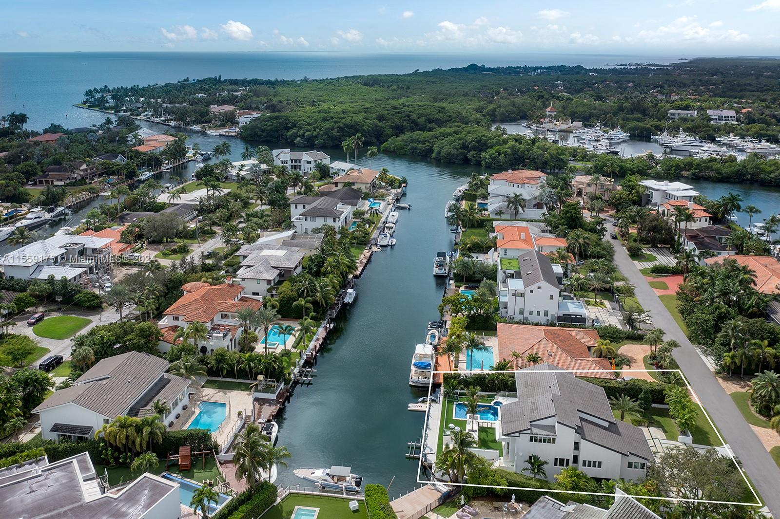 Nestled within the prestigious gated community of Sunrise Harbor in Coral Gables, this luxurious waterfront residence boasts 100 feet of prime waterfrontage and a private dock granting direct access to Biscayne Bay. The property is adorned with custom-designed closets and a spacious laundry room, offering ample storage space. A gourmet kitchen, wine room, and glass bar enhance the allure of this exquisite home. Situated mere minutes from Coconut Grove, South Miami, top-tier schools, and Miami International Airport, this coveted location affords unparalleled convenience and prestige. Additionally, residents can indulge in the community's amenities including a gym, playground, and office, ensuring both leisure and functionality at their fingertips.