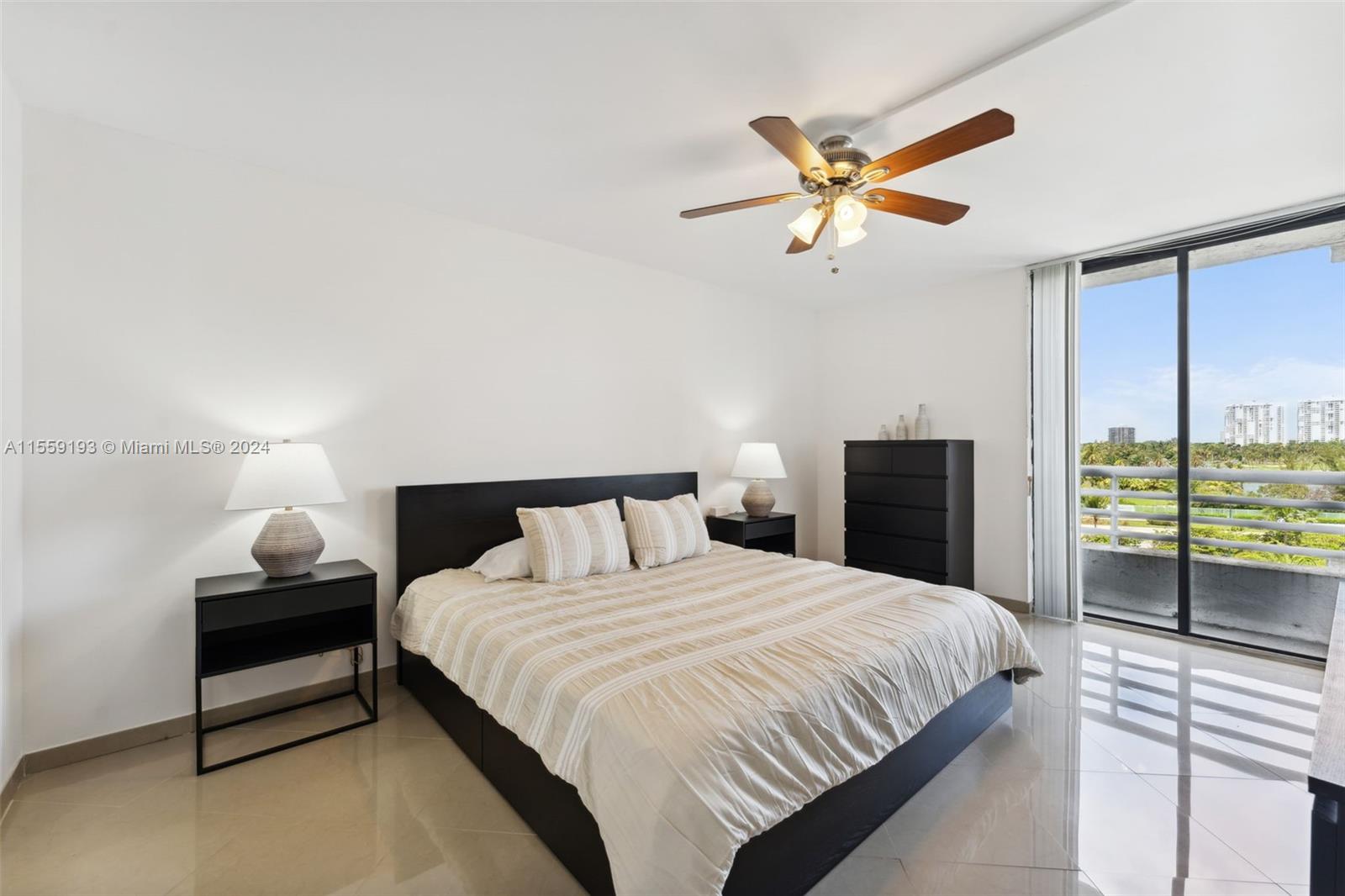 Spacious primary bedroom with private balcony.