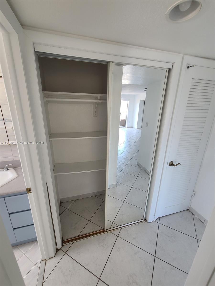 Utility closet off the hallway to the room and bathroom