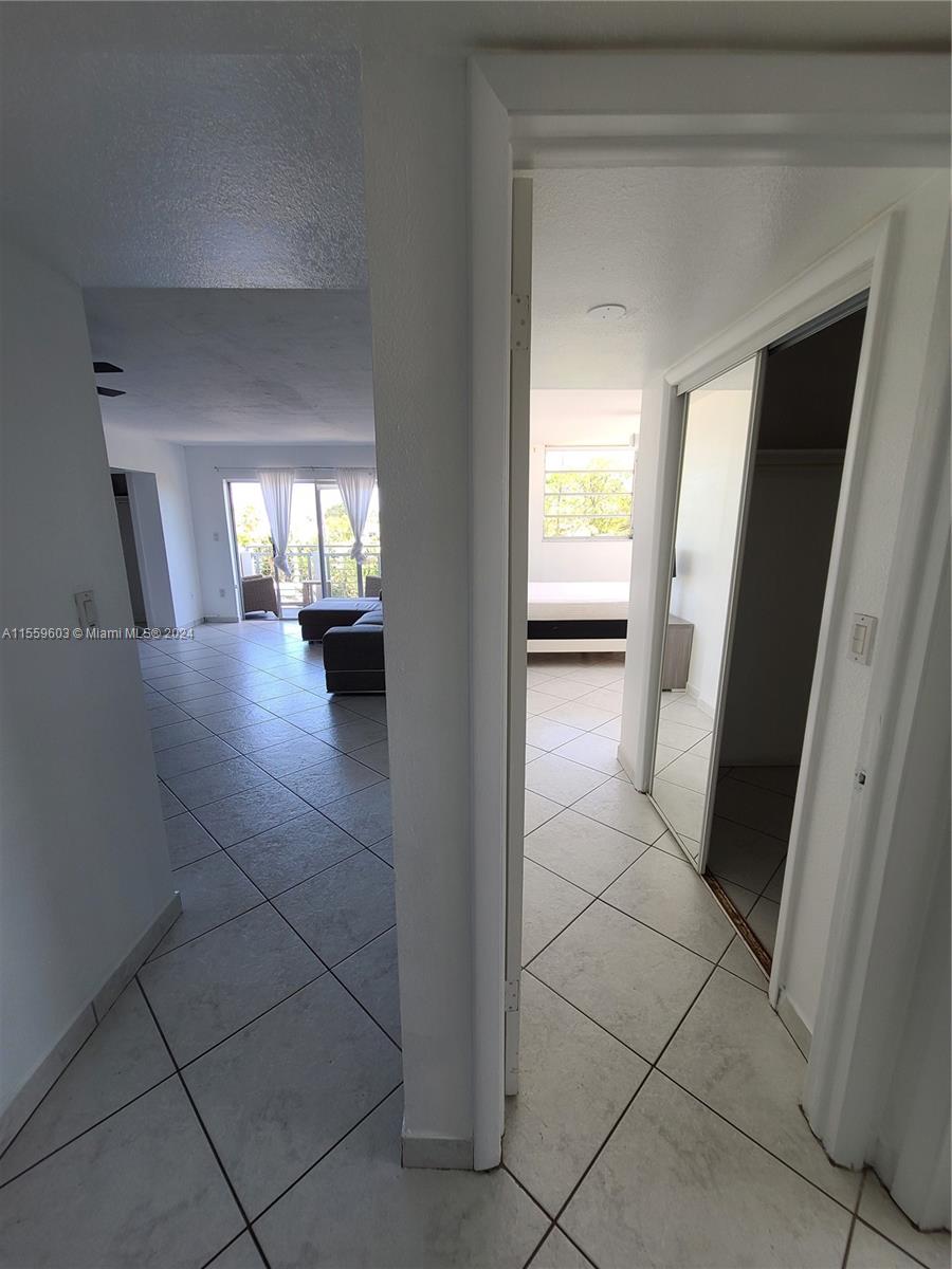 View of living room and master bedroom entrance from the hallway closet