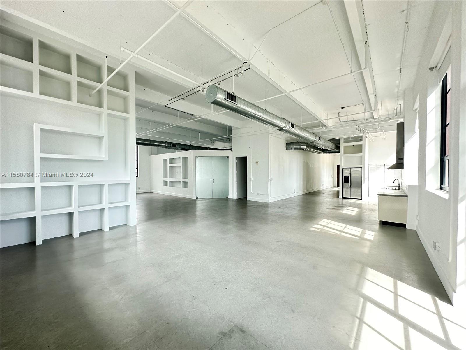 Bright White Loft Space! Tons of Light. Large open floor plan, with 15' ceilings, this industrial loft is available for short term rental min 3 months - 9 months. 2 enclosed bedrooms and 1 large bathroom plus pantry with full size washer dryer.  Large wrap around balcony and 1 parking included. Call or text LA easy to show unit vacant.