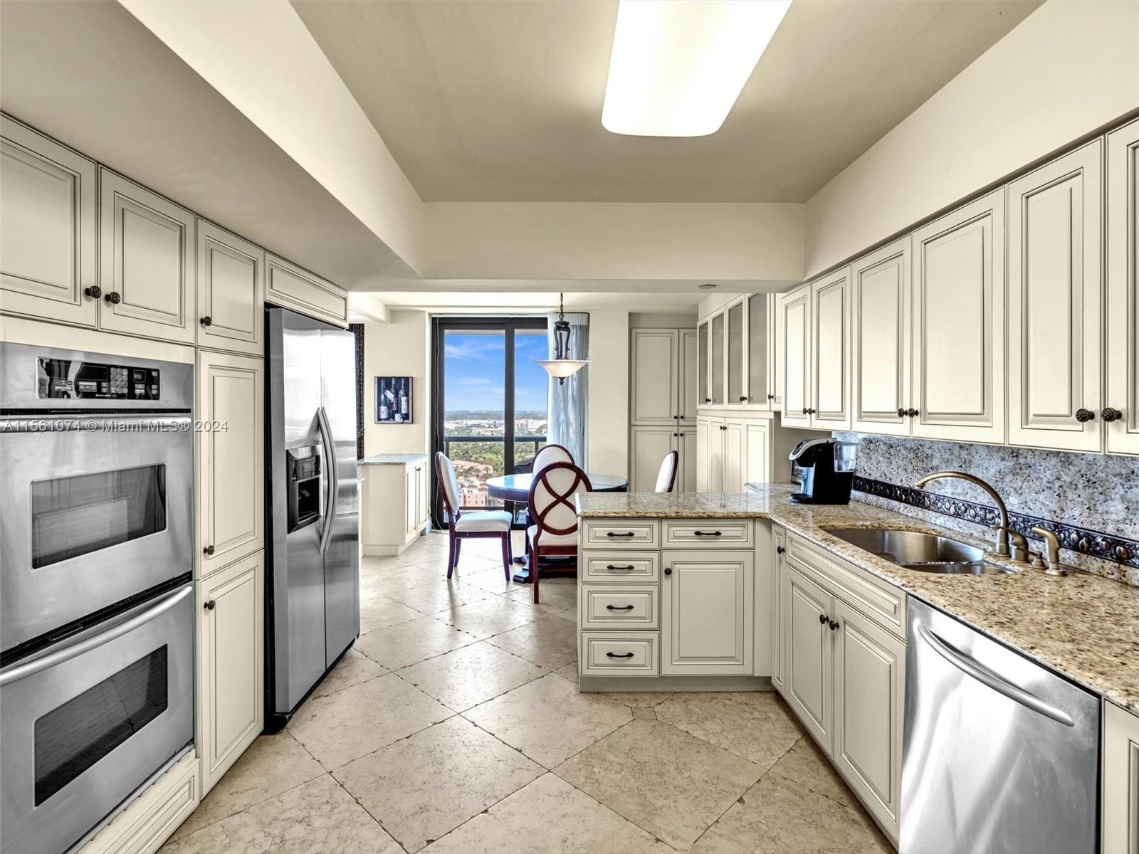 UPDATED EAT IN KITCHEN WITH STAINLESS STEEL APPLIANCES AND GRANITE COUNTERS