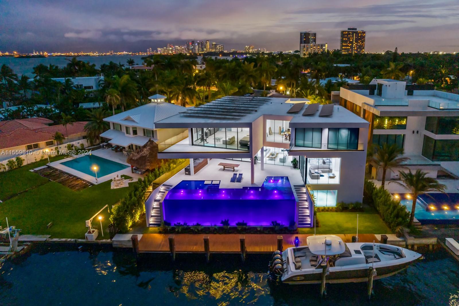 Stunning Bay/Canal Contemporary Residence- 100+ ft on deep water - New Construction (total of 12,200 SF under A/C).  Loaded with ultra luxury finishes and very little use - 35KM solar electric generator w/six Tesla power walls & Travertine exterior walls.  All custom lighting & sound throughout.  Unique glass elevator to all three levels.  Generous sized rooms and large closets.  Art Gallery, Office-Library, amazing 12 car garage, play room & wine cellar.  Breathtaking views of the Open Bay, City lights and tropical gardens from all rooms.  Huge covered Patio + Summer Kitchen w/50ft infinity edge pool.  Full dock & Boat Lift. Double gated 24/7 Island in the heart of Miami.  Minutes to Design District, Beaches, Downtown Miami & Bal Harbour.  Owner Financing Available.