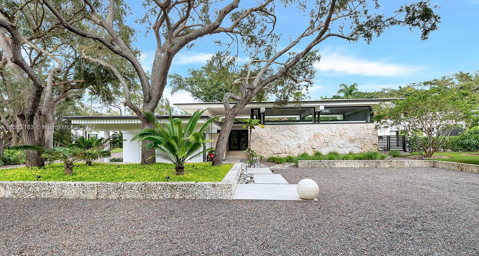 This Mid-century marvel by architect Robert B. Browne has been meticulously revitalized for modern living. Nestled in a prime Pinecrest location, this home boasts modern upgrades and robust construction, featuring a new roof, PVC plumbing, and floor to ceiling impact windows and doors. The main residence offers 5 bedrooms, 4 full baths, and 2 half baths. It showcases an Italian kitchen with sleek steel appliances and quartz countertops. This property includes a separate 831 sq ft independent 1 bed/1 bath guest house. The 37,592 sq. ft. corner lot is meticulously landscaped with oolite and gravel driveways, new pool, fire pit, and covered patio, ideal for outdoor entertaining. Complete with an oversized 4+ car A/C garage, this property marries vintage charm with modern luxury.