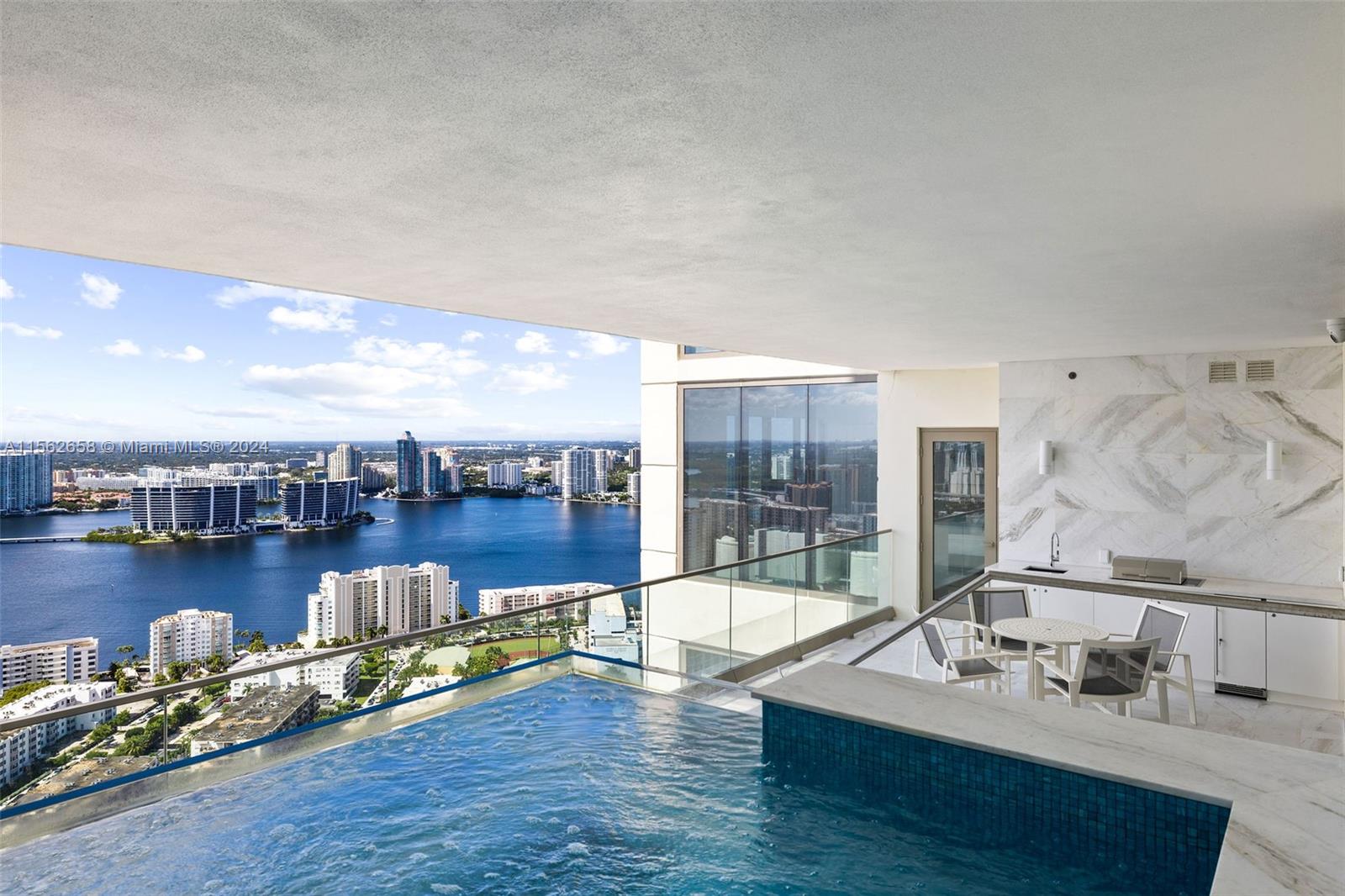 Custom one-of-a-kind 06 unit with its own private swimming pool. This masterpiece of opulence is located on the 34th floor of the ultraluxurious & secure Estates at Acqualina in Sunny Isles Beach. Boasting 3 generously appointed bedrooms & 4.5 lavishly designed onyx & marble bathrooms, meticulously crafted to cater to those who seek the pinnacle of coastal oceanfront living designed to ensure utmost privacy & comfort. Primary Suite encompasses the bedroom with glorious sunset views, substantial bathroom inc shower, free standing tub, 2 sinks, Toto toilet, and Italian closets. Beautifully appointed Living/Dining areas with a high-end kitchen and La Cornue stove, all at the highest level of quality, which lead onto the generously scaled swimming pool terrace. A must see and easy to show.