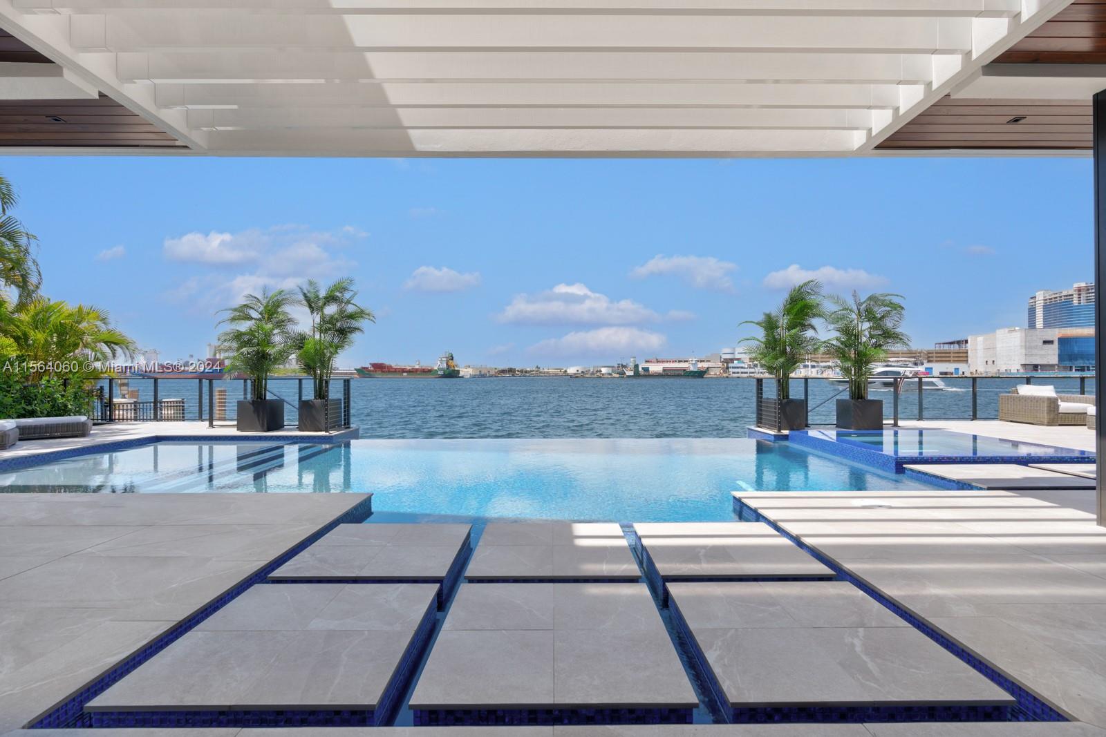 Absolutely stunning new modern waterfront estate with ultra high-end finishes. CO issued! Available turnkey! Enchanting wide water views of the intracoastal, ocean inlet, & a parade of cruise ships & yachts. Walking distance to Pier 66 marina, dining, and beaches. Only 10 mins to FLL airport. Floor-to-ceiling sliding glass doors, floating staircase w/ glass banister, massive glass pivot door, custom Italian cabinets & porcelain tile throughout, Miele appliances, 3 wet bars, club room, & 1st floor suite, optional 6th bedroom. 2 primary suites w/ spa baths & expansive closets, and 2nd floor lounge all with wide water views. 4 private terraces, motorized curtains/shades, 11 ft ceilings on 2nd floor, outdoor kitchen with covered dining, ample entertaining space, and a resort style pool & spa.