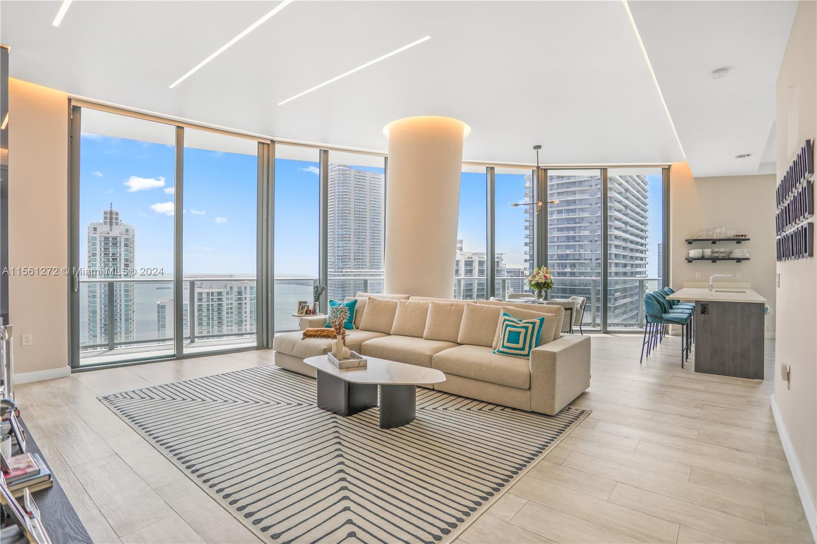 Experience luxury living in this Lower Penthouse Unit located in the heart of Brickell. Enjoy expansive views spanning from Downtown to Coconut Grove from your spacious wrap-around balcony w/ 4 points of entry. This unit boasts custom woodwork throughout, including a foyer partition, custom kitchen cabinetry, hand-carved TV wall unit from Europe. The solid wood doors add a touch of elegance to this already stunning 2/2 plus den unit. Technology features include an automatic Somfy shade system throughout & custom overhead LED lighting with individual remote control dimmers for all rooms. This PH with 11ft Ceilings is different from the other 03 line units. The master bedroom is wrapped in luxurious Goldflake wallpaper from Italy.