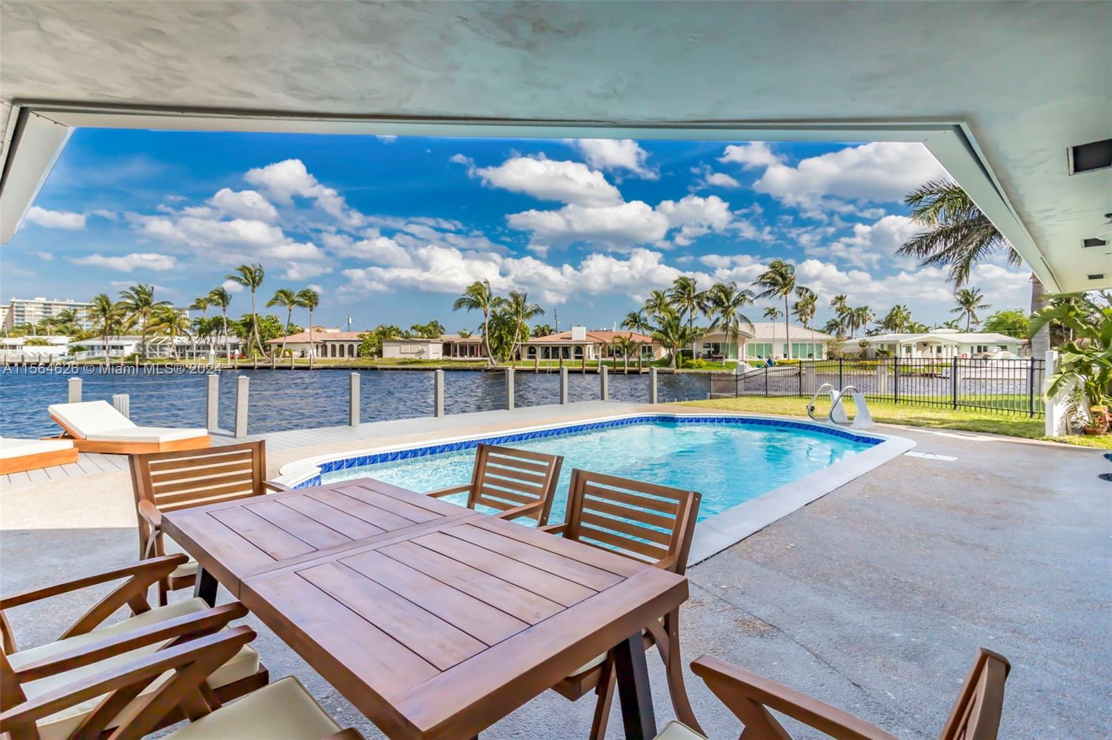 Tastefully renovated Waterfront Home on a canal in Pompano Beach with expansive Water Views, 110 feet of Water-Frontage, Pool, Dock, Sun Deck, 2-Car Garage, New Floors, New Roof (2020), updated Electrical, and Plumbing. Featuring 3 Bedrooms, 3 Bathrooms, and a waterfront Primary Bedroom.  Open Kitchen with a modern design, Quartz Countertops and Stainless Steel Appliances.  Large Backyard with Waterfront Swimming Pool and Sundeck, perfect for entertaining and relaxing.  Only one fixed bridge at Federal Highway.