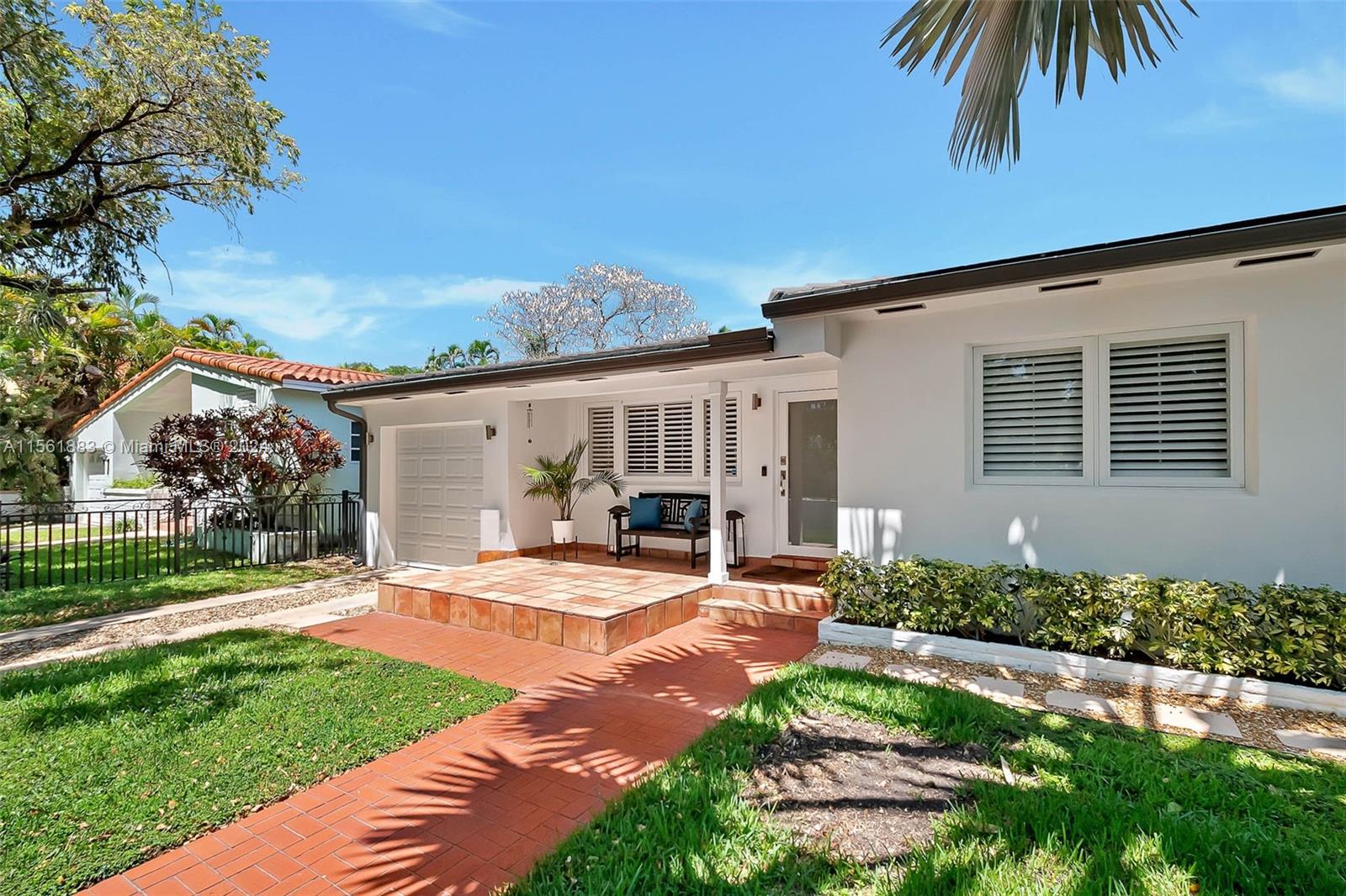 Discover Coral Gables charm in this enchanting home, where a blend of traditional allure and modern updates await. Situated in a walled and gated sanctuary on a lush, canopied street, this property welcomes you with marble floors, a captivating wood ceiling with exposed beams, and wood shutters on windows. Updated features include impact windows and doors, a newer roof, and modernized electrical and plumbing systems. Move-in ready, it boasts two spacious ensuite bedrooms with wood floors, including a primary bedroom with dual closets. A large sunroom leads to the yard, your private oasis, while the laundry room is conveniently housed in the marble-tiled garage. Just blocks from Granada Golf course and Downtown Coral Gables. Don't miss the opportunity to make this special home yours.