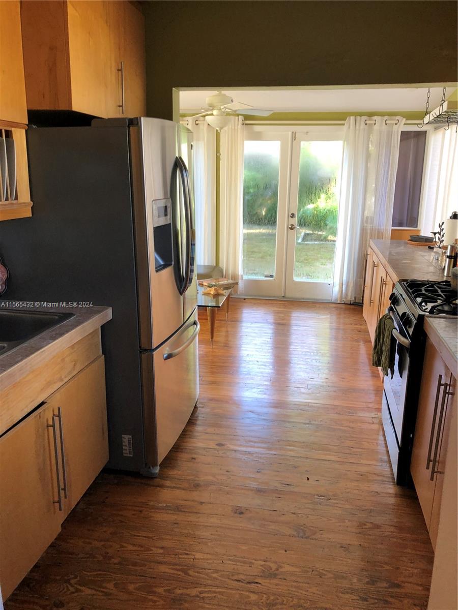 Kitchen with stainless steel appliances and space for additional dining area or family room