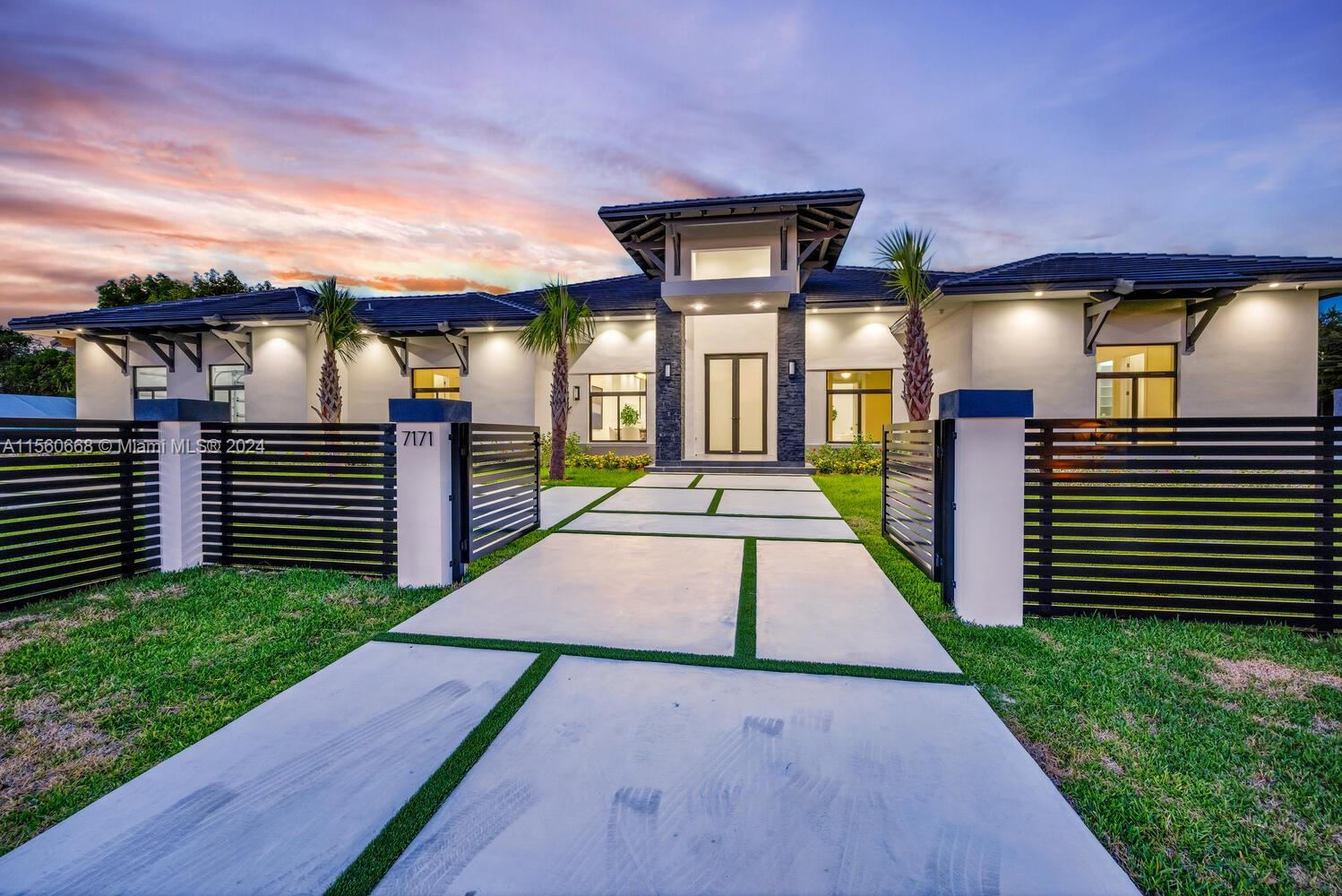 This newly built, sleek contemporary Glenvar Heights home, is set on a gated corner lot of 29,411 sq ft, adorned with impressive 12-foot ceilings. It features 5 bedrooms & 5 full bathrooms, including a cabana bath. The kitchen, is outfitted with a grand island, top-of-the-line Calacatta countertops, & a pantry space. The primary suite boasts high-end bathroom finishes & a spacious walk-in closet. Crafted for organization, each additional bedroom includes built-in closets. The home's ambiance is enhanced by smart-home technology & built-in speakers. An outdoor private oasis with a swimming pool, hot tub, & covered terrace is perfect for entertaining. A discreet 2-car garage on the side complements the home’s streamlined façade, marking this property as the pinnacle of upscale family living.