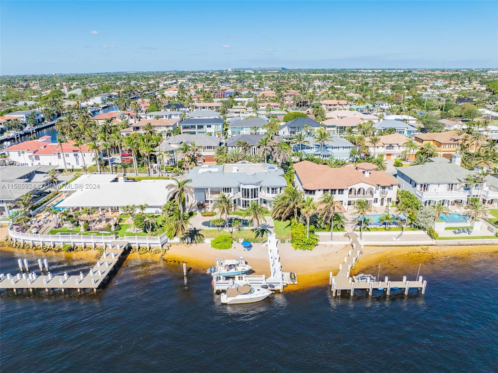 Welcome to waterfront luxury living in Lighthouse Point! This stunning estate offers an unparalleled oasis on a prime lot, boasting a private beach and 100 feet of direct intracoastal water frontage in a serene no wake zone near the inlet. Enjoy the ultimate in waterfront entertainment with an extended L-dock featuring a boat lift and jet ski dock, complemented by an oversized covered outdoor space. This elegant 5-bedroom, 6-bathroom home spans over 6,000 square feet of luxury living on a spacious 175-foot-deep lot. Grand foyer leading to floor-to-ceiling windows showcasing the stunning outdoor vistas. Large kitchen, wet bar, fireplace, home theater, and a separate guest apartment with its own entrance. Don't miss your chance to own a piece of waterfront paradise in Lighthouse Point.
