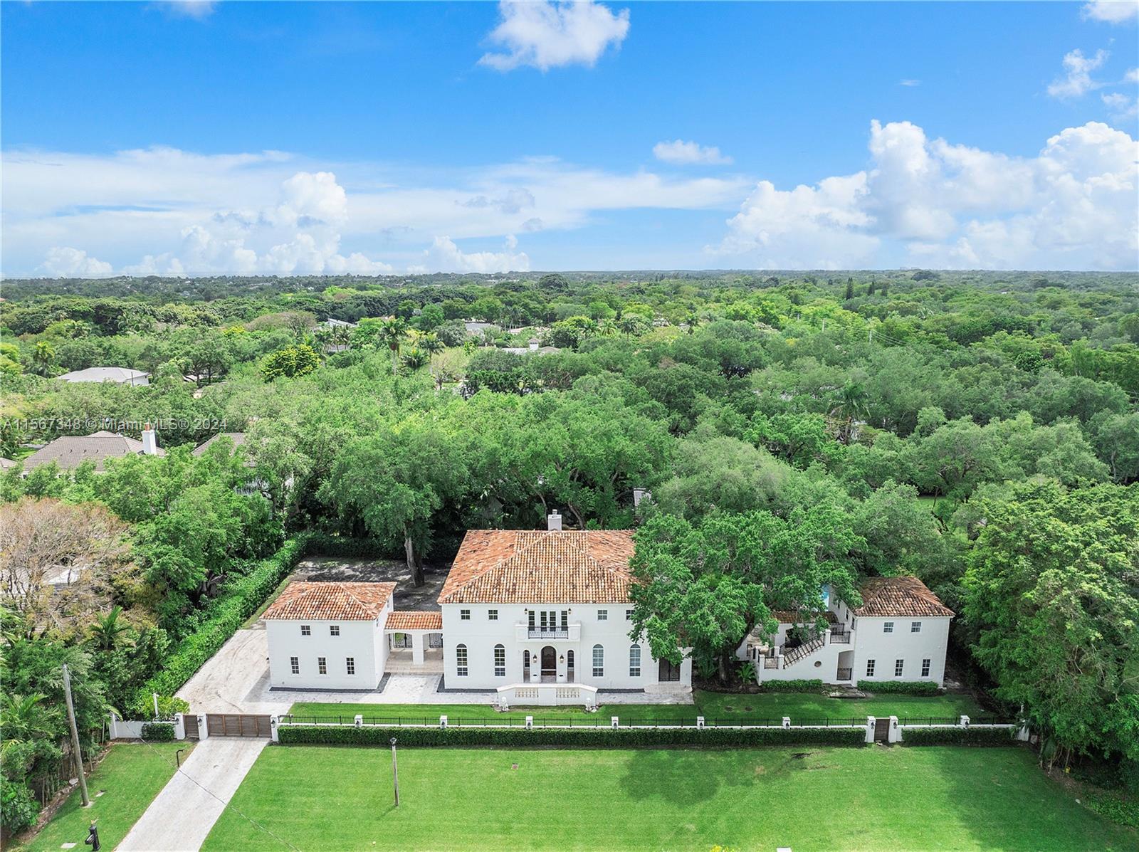 Sunset Villa. Step into the refined world of French architecture with this stunning Coral Gables home. You are welcomed by a grand foyer, modern double-sided fireplace, wood floors throughout, coffered ceilings and an elegant curved staircase. Spacious living areas and formal dining,14-foot ceilings and a gorgeous open kitchen, are filled with natural light streaming through expansive windows. A warm family room completes the cozy yet elegant atmosphere. Outside, the oasis attracts with covered terraces, open-air patios and salt-pool for relaxation & luxury. Main suite is a sanctuary with large walk-in closets and sophisticated bath. Unique fully renovated property is a collection of interconnected structures connected by breezeways. Smart-house system for audio/visual/lighting & home Gym