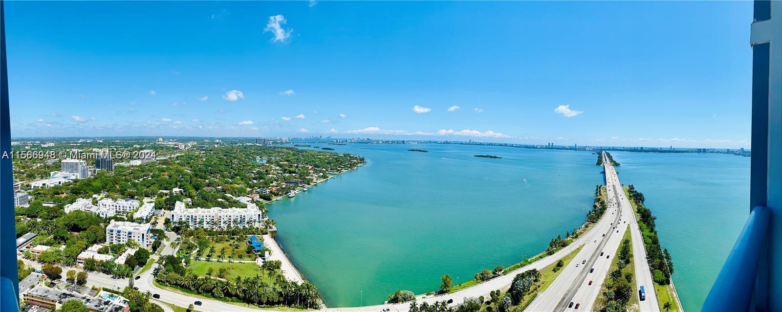 Kitchen- Floor to ceiling windows featuring Vaulted ceilings
