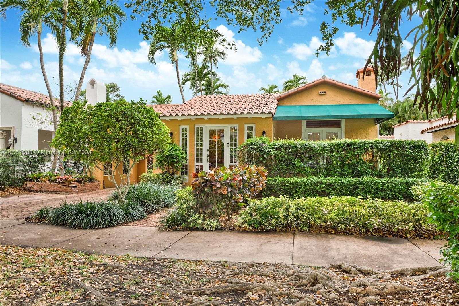 South Coral Gables, just off of S. Alhambra Cir. this old Spanish home epitomizes timeless charm. Located in the sought-after Sunset Elementary School district, it offers a serene historic retreat amidst lush surrounding homes. Classic features like terracotta roof tiles and arched doorways greet visitors along a tree-lined pathway. Inside, a sunlit foyer with intricate tile work welcomes guests to a spacious living room with wooden beams and vaulted ceilings. The kitchen, with custom cabinetry and granite countertops, invites culinary adventures. Two bedrooms, including a primary suite with an elegant en-suite bathroom along with a cozy den. A separate guest house offers an additional bedroom and bath - truly a versatile space. Outside, a brick paver patio for you to relax and entertain.