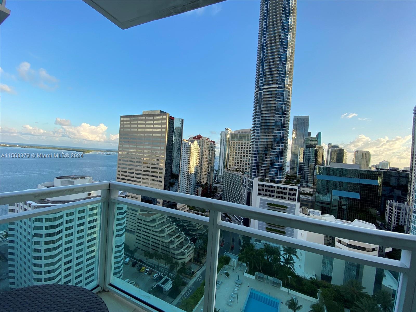 Centrally located, bright, spacious and tastefully furnished 2 bed 2 bath unit, large balcony with amazing water and city views in building with resort style amenities: two large heated pools, jacuzzi, BBQ area, gym, 24 hours concierge and more. Walking distance to malls and several restaurants and shops.