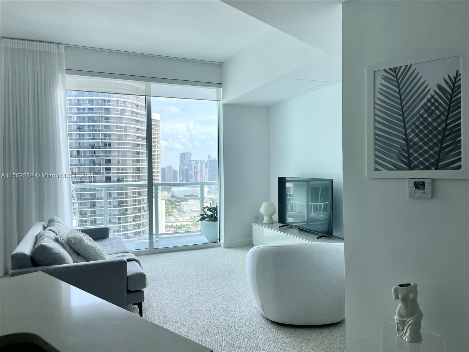 Beautiful light-filled high floor condo with amazing downtown views. Modern design, stainless steel appliances, granite counter tops and high ceilings, walk-in closet, electronic shades, stacked washer and dryer in unit. 
Located across the street from Margaret Pace Park and minutes away from Midtown, Downtown, Wynwood, Brickell, Miami Beach, Design District. 
Amenities: 24-hour security and concierge, 24-hour valet parking, fitness center with sauna rooms, two outdoor pools, theater room, convenient store in the lobby, beauty salon, dentist, cafeteria.
Can be sold with furniture.