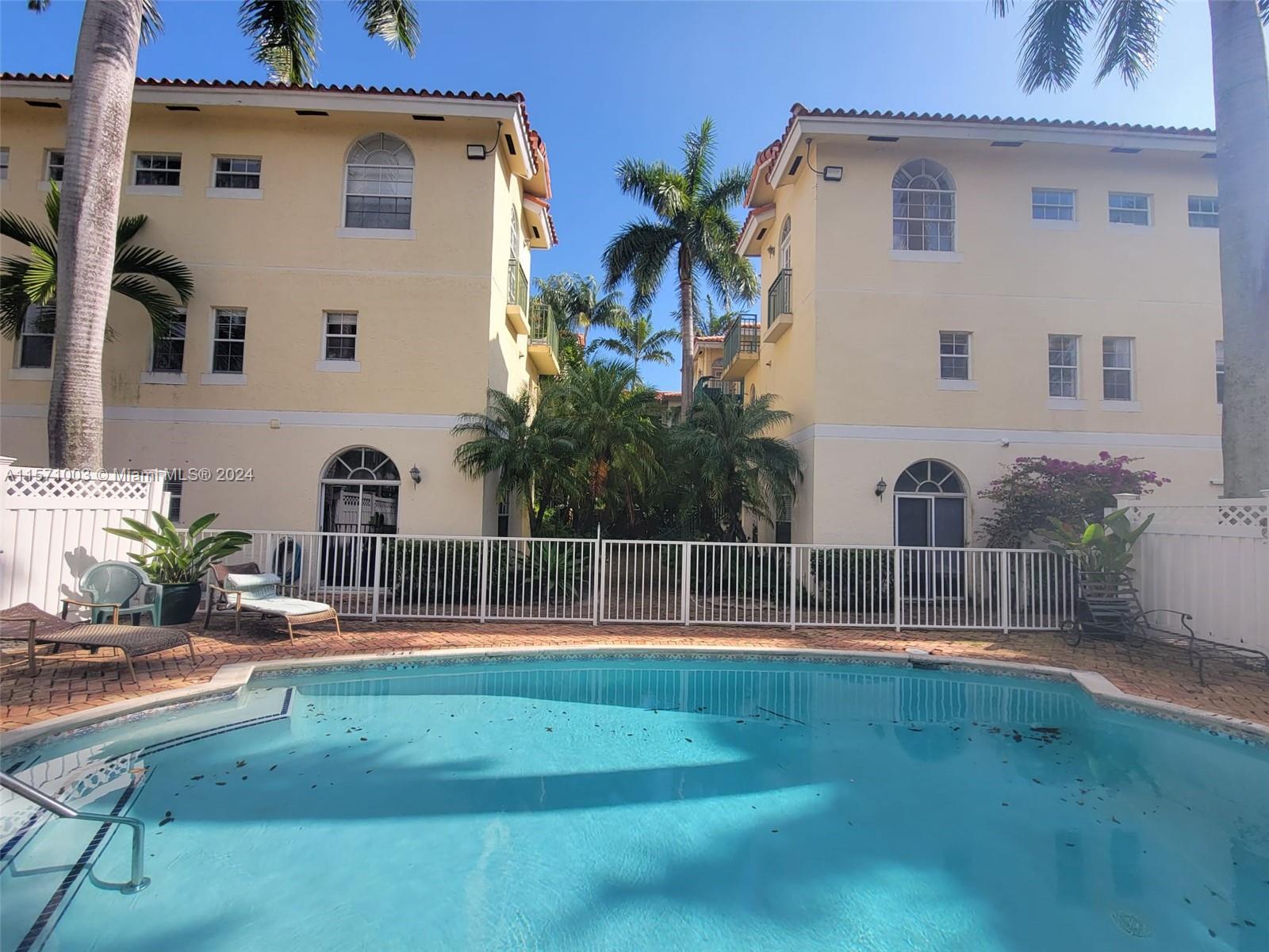 Cozy Spanish-style condo-townhouse in Coconut Grove. It is located in a private gated community with a two-story layout, offering relaxing garden and pool views. It is a corner unit with a spacious floor plan and plenty of natural light. The ground floor includes a half bathroom and ceramic flooring, while the upper level features 2 bathrooms and 2 bedrooms with wooden floors, a walk-in closet in the master bedroom, and a 16-foot high ceiling. This boutique community, private and peaceful with only 16 units, is surrounded by beautiful trees and bougainvillea.