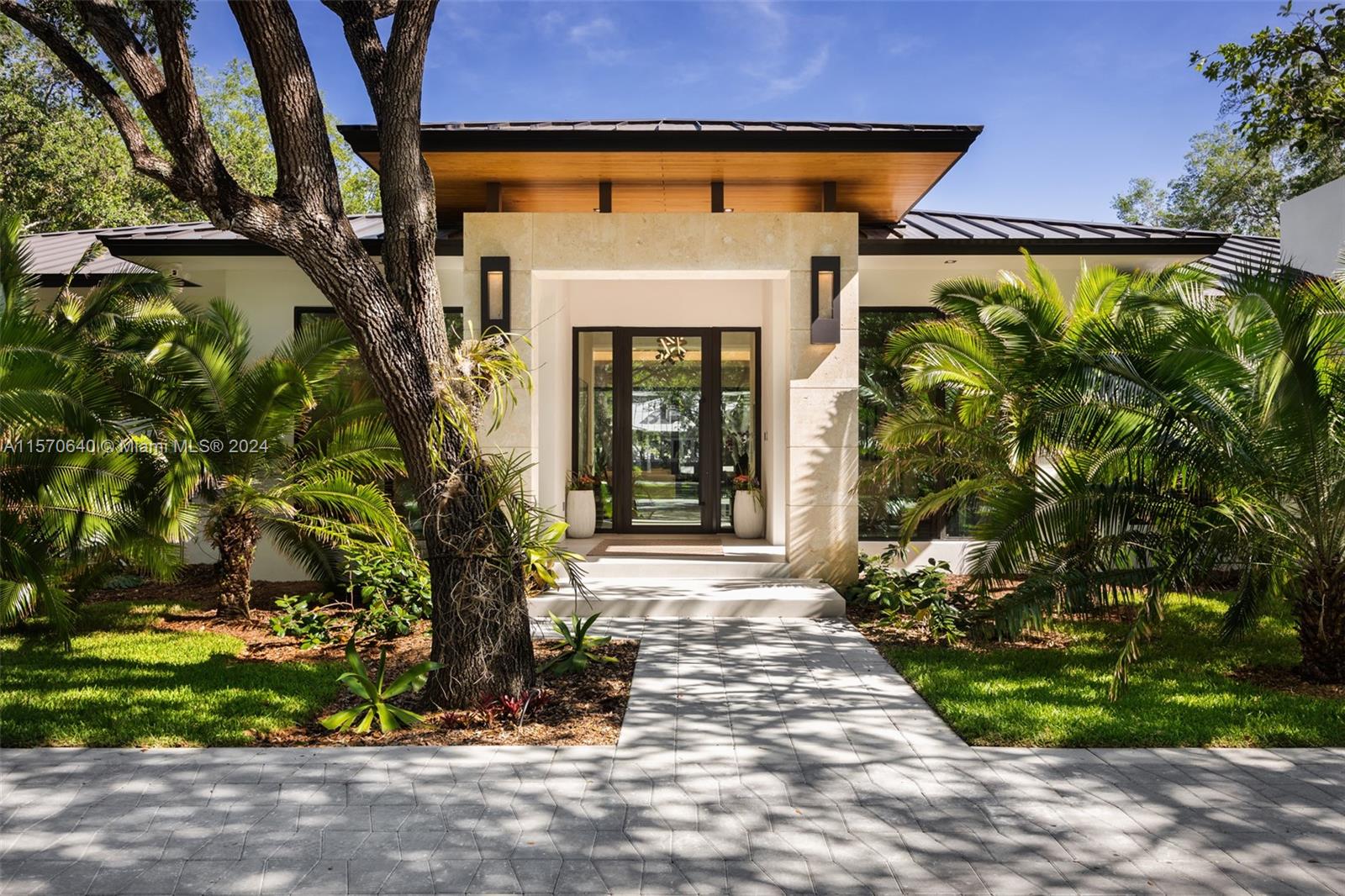 This custom-built, new construction home in Pinecrest exudes luxury, tranquility + style at every turn. Built in 2024 by Kenner homes, this property is situated on a quiet street surrounded by lush foliage + over 20 Oak trees, creating a private canopy over the home. Upon entering, you'll be welcomed by bright, open living spaces + views of the patio/pool from nearly every room. The home includes a full built-in bar w/ double wine coolers, chef's kitchen w/ both gas + induction cooking, hidden walk-in party, large laundry room, summer kitchen + outdoor shower, among other bonus features. The primary suite is a true escape with a home gym, built-in coffee bar, generous walk-in closets + spa-like bathroom. The attention-to-detail is impeccable throughout this home; it is not to be missed.