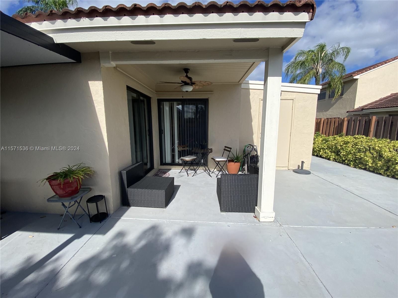 View of the patio area - shown are the two sliding doors in the living and dining areas - outdoor closet storage area shown in the background