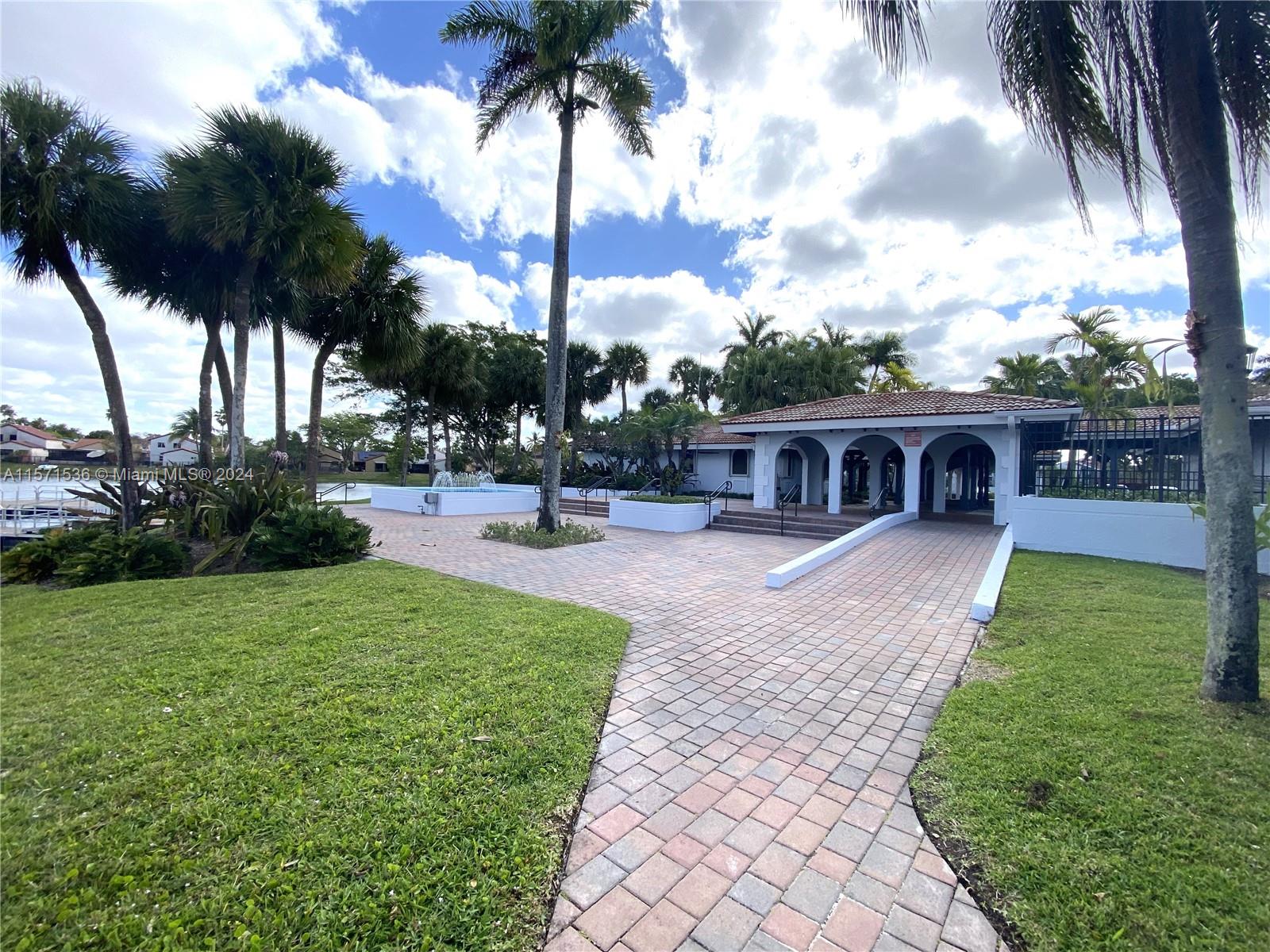 Clubhouse area near the pool and walking pier in the background
