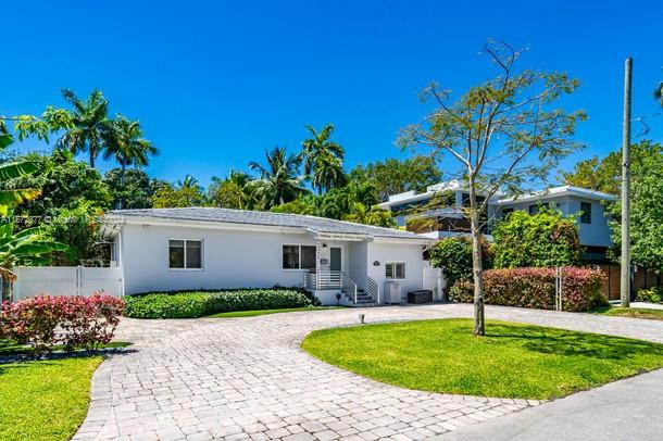 Nestled in the heart of the coveted North Coconut Grove, this exquisite residence boasts an enviable location. Step inside to discover a spacious three-bedroom, two-bathroom sanctuary that exudes warmth and elegance. The home has been meticulously updated, featuring rich wooden flooring that seamlessly flows throughout the entire space, lending it a timeless charm. The property sits on a generously sized lot, surrounded by lush greenery that promises privacy and tranquility. At the rear, you’ll find a stunning built-in deck—an expansive outdoor haven perfect for hosting gatherings or simply enjoying the serene environment. Whether it’s a lively barbecue or a quiet evening under the stars, this deck is the ideal backdrop for making lasting memories.