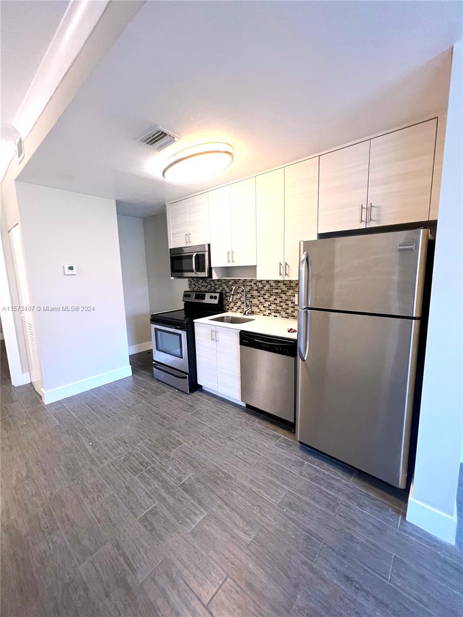 Welcome to the City Beautiful! Just a 10-minute walk from Miracle Mile, this tastefully updated, move-in ready 1/1 unit features Quartz Countertops, Stainless Steel Appliances, and in-unit Washer/Dryer. Modern Wood Plank Ceramic Tile, Central AC + Ceiling Fan in the living area, and lots of natural light as this is a corner unit. Whole building has Impact Windows and Doors, as well as 24-Hr Video Surveillance. This is a second-floor unit, no elevator. Pets allowed up to 30 lbs with non-refundable pet deposit. Water, sewer, trash and pest control included.  Walkable to some of Miami's best dining and shopping, close to all main roads/highways. **Please text only*** Listing Agent for any questions. Please use Showing Assist to view this unit.