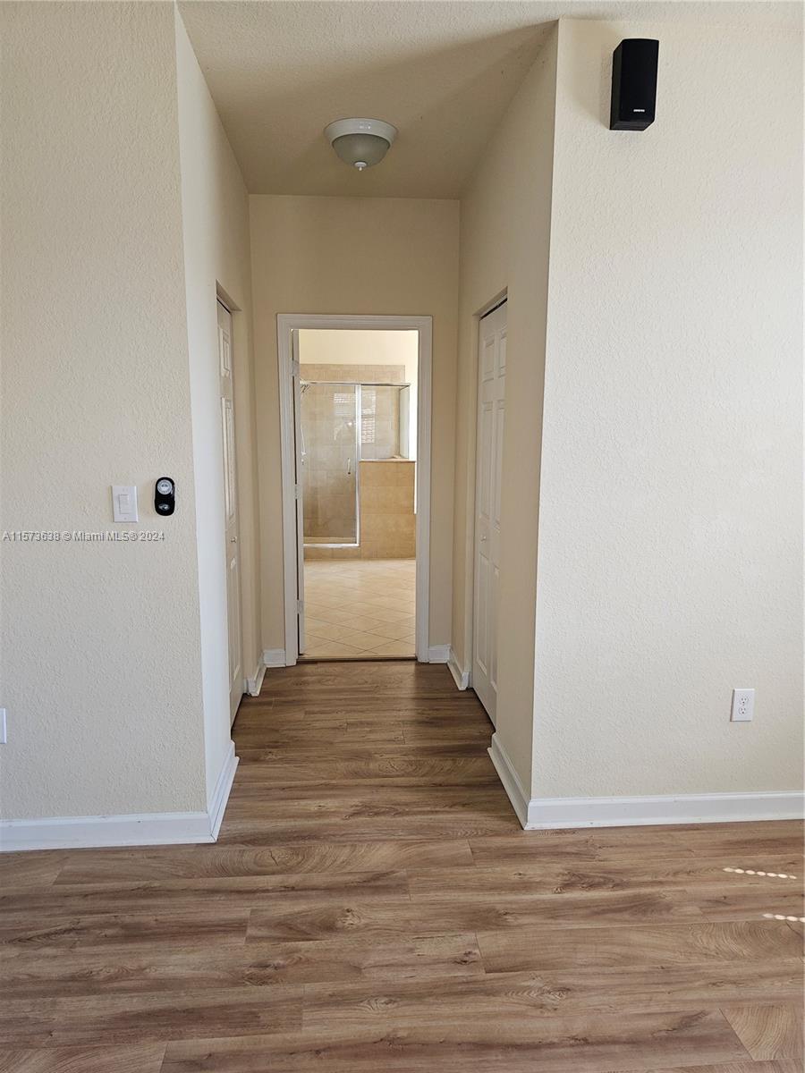 Master bath view from bedroom. Two walk-in closets.