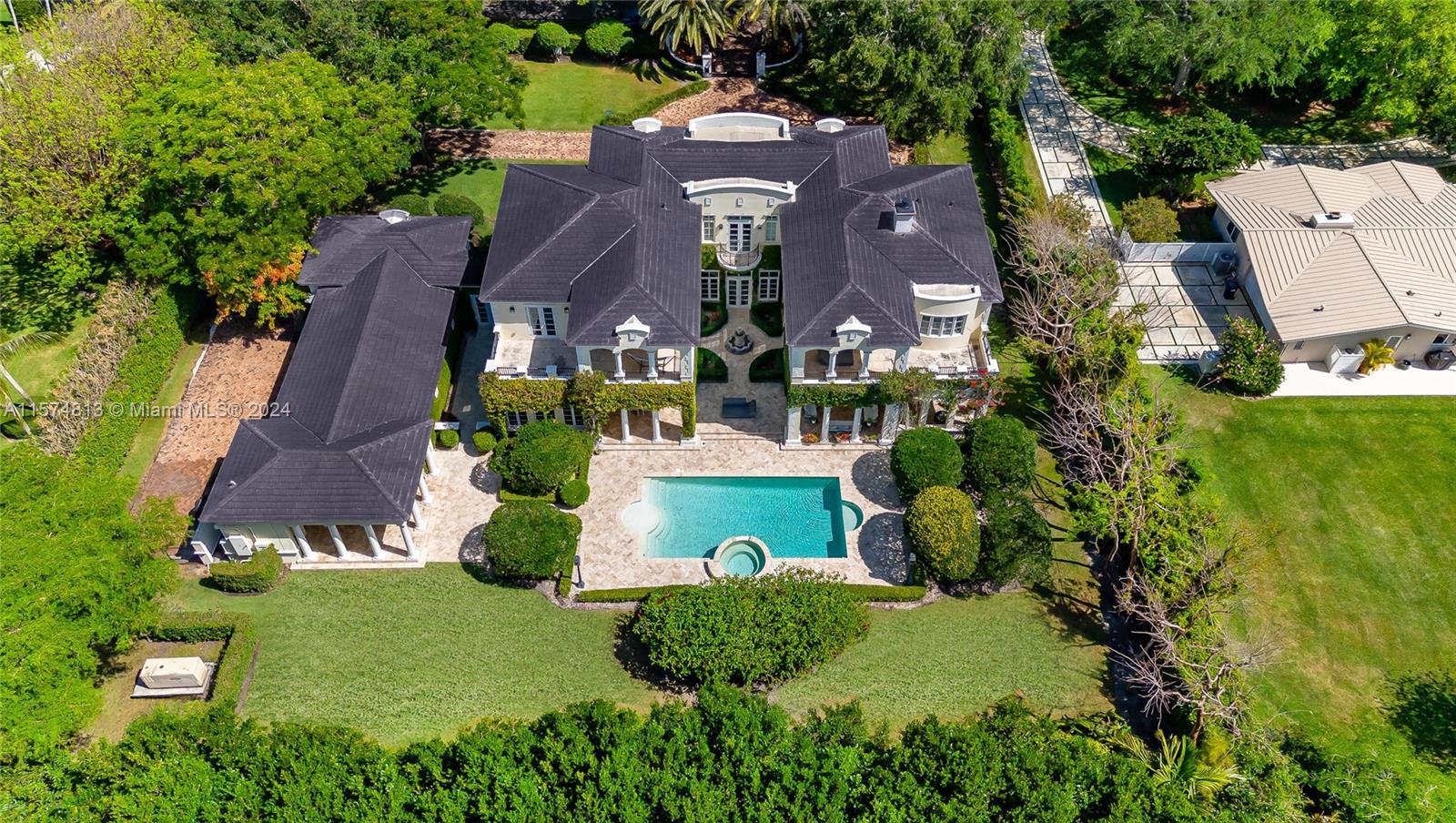 This exclusive French Neoclassical Pinecrest Estate is nestled on a great lot adorned with lush landscaping, behind a private gate offering privacy. Offered FULLY FURNISHED, available May 15, 2024! Inside, find a convenient guest bedroom with a full ensuite downstairs, along with a staff room adjacent to the laundry and kitchen. Upstairs, the master bedroom wing features a large office, spacious bedroom, his and hers closets, and a luxurious ensuite bathroom. Three additional bedrooms upstairs, each with their own bathrooms, provide plenty of space for a growing family. Outside, enjoy the serene backyard with a refreshing pool, outdoor kitchen, and ample entertainment space. Located in a great school district and nearby amenities, this home offers both comfort and convenience.