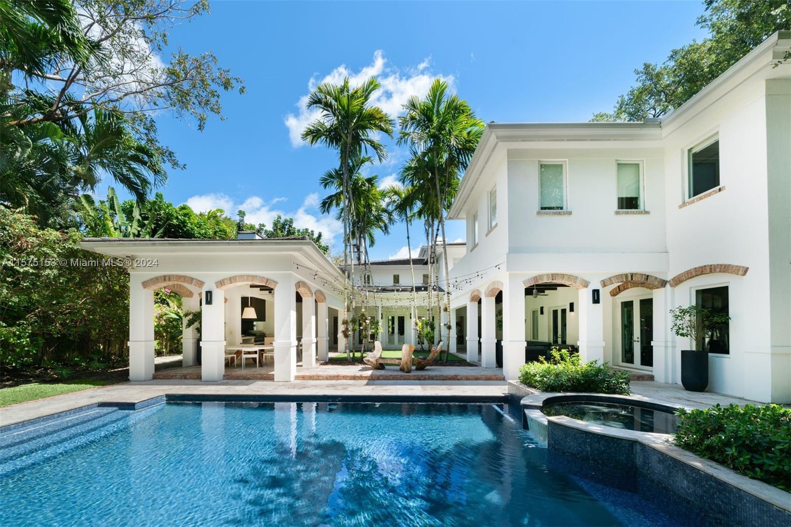 On a sprawling 20,000 SF gated lot in an exclusive, idyllic location just minutes away from Brickell, Key Biscayne, and Coconut Grove, this 8,881 SF, 6-BD, 6.5-BA residence offers a bright and airy ambiance, with abundant natural light cascading through volume ceilings. The chef’s kitchen includes an expansive center island, premium appliances, quartz countertops, and floor-to-ceiling custom cabinetry. French marble baths and hardwood floors throughout upstairs. Beautiful outdoor entertainment spaces feature a summer kitchen, heated pool/ jacuzzi, Travertine covered patios, and lush landscaping. Ample parking is provided by a 4-car garage with car lift, and Chicago brick driveway. Additional features include a wine cellar, impact windows and doors, and interior/exterior audio system.
