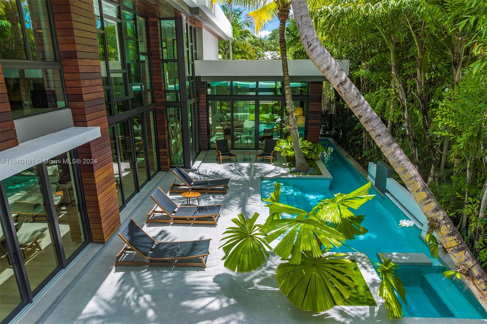 Indulge in the ultimate Coconut Grove lifestyle in this extraordinary modern estate by renowned architect Charles Treister. Perched atop a ridge 21 ft above sea level and surrounded by a lush garden, this unique Tri-Level home seamlessly blends indoor and outdoor spaces for a tranquil tropical experience. Boasting an array of meticulous details and exquisite craftsmanship, you'll be captivated by a spectacular floorplan with 7 bedrooms and 7/2 bathrooms, rare to find basement w/ A/C, separate guest suite apartment, elevator, and exquisite finishes throughout. Experience an outdoor oasis with glowing pool & spa, covered terrace, summer kitchen and outdoor shower. This modern smart home offers it all with a full house generator, 2 car garage in desirable North Grove and prestigious schools.