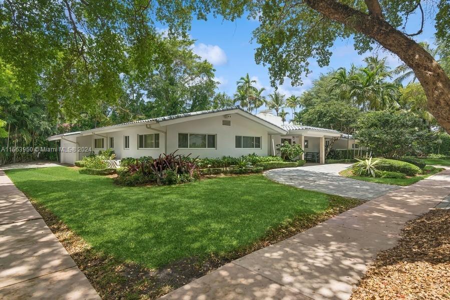 Spectacular North Gables Tropical Oasis! This spacious 3,375 sqft, 1-story 3bd/3bths + wood-paneled study, offers a perfect blend of classical elegance and modern updates. Located on a 16,800 sqft corner lot, the covered entry leads into a lg formal living & formal dining, which opens to an extra-lg covered terrace, exuding breathtaking views of the exquisite, lush backyard, open pool area & summer kitchen! Ideal for alfresco dining and entertaining! The serene primary suite, boasts double walk-in closets, a bathroom w/separate sinks, makeup vanity and lg shower. The gourmet kitchen is a chef's dream, featuring all wood & granite finishes. A spacious family rm w/wet bar,also opens to the pool area. Steps away from Country Club Prado & excellent Schools! Truly Florida living at its finest!